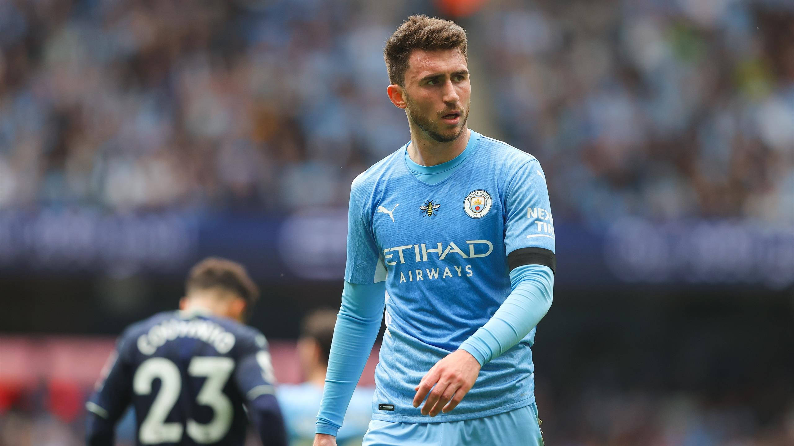 Aymeric Laporte, light blue Manchester City jersey, sunlit pitch, 2K Desktop Wallpaper
