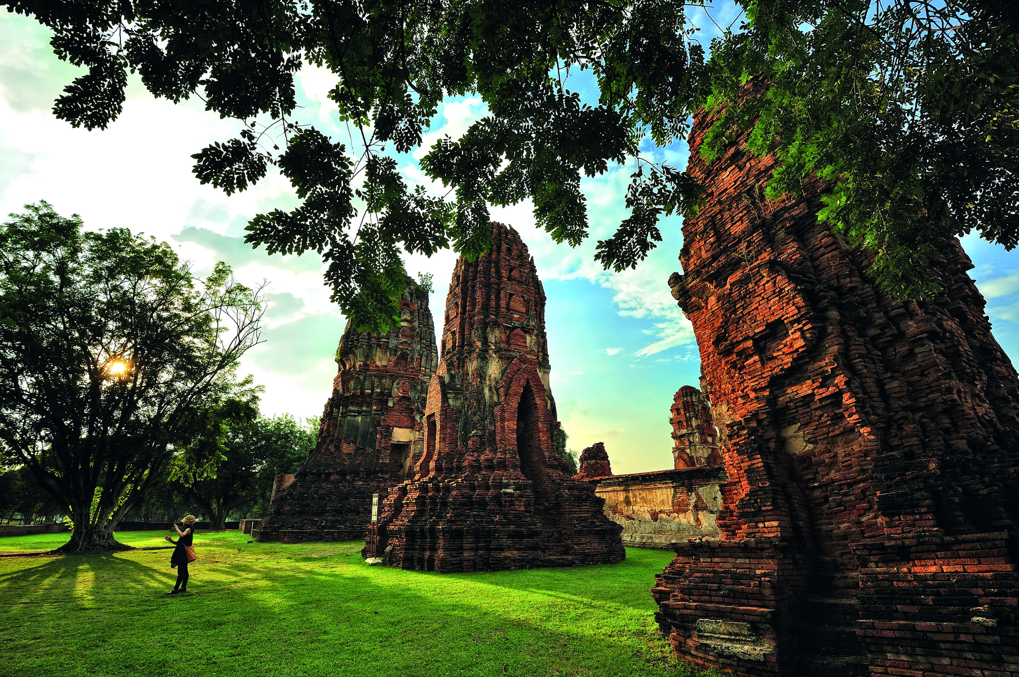Ayutthaya Historical Park, ancient red brick temple ruins, sunlit grassy field, 2K Desktop Wallpaper