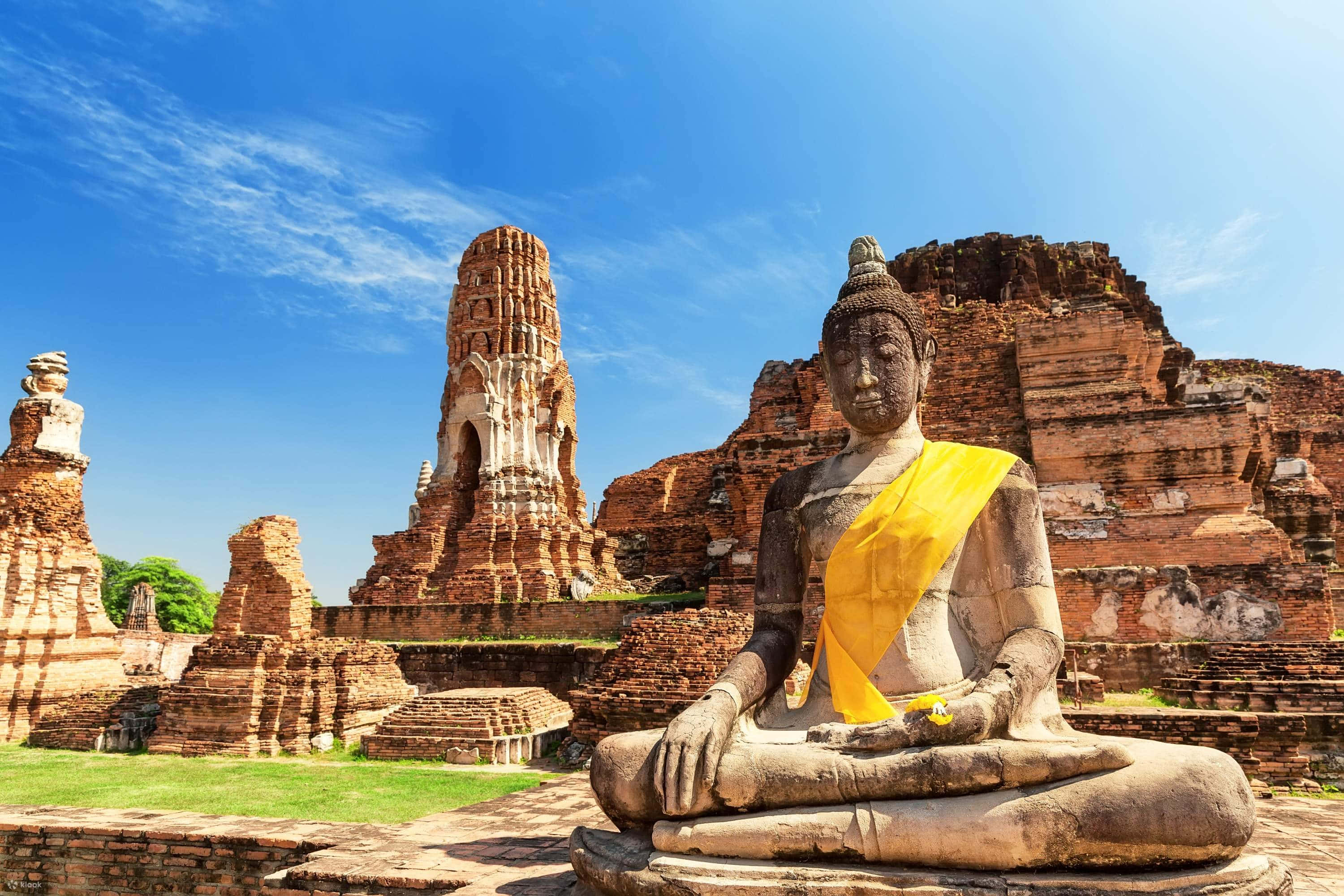 Ayutthaya Historical Park, stone Buddha statue, bright yellow cloth, 2K Desktop Wallpaper