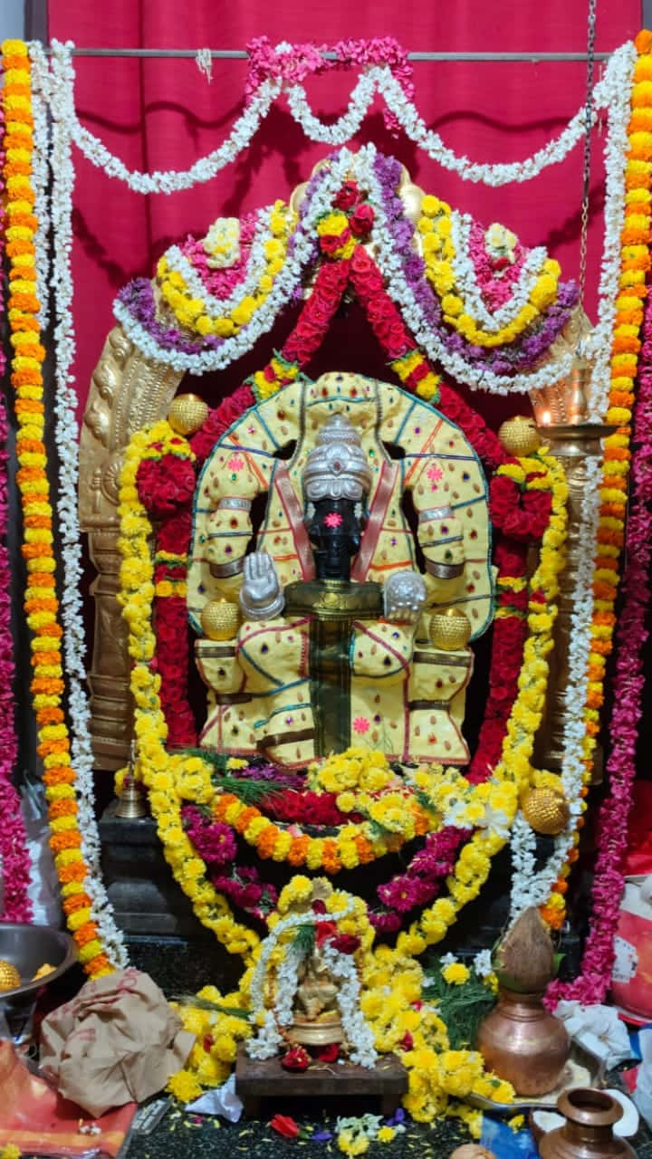 Ganesh, golden deity statue, vibrant yellow red and white floral garlands, HD Phone Wallpaper