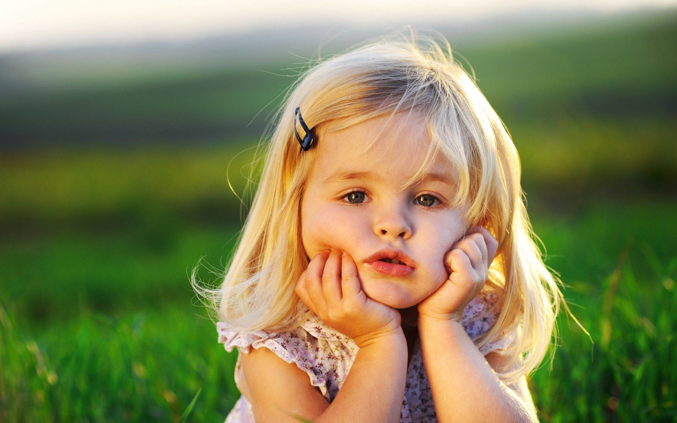 Baby Girl, blonde girl, sunlit green field, 2K Desktop Wallpaper