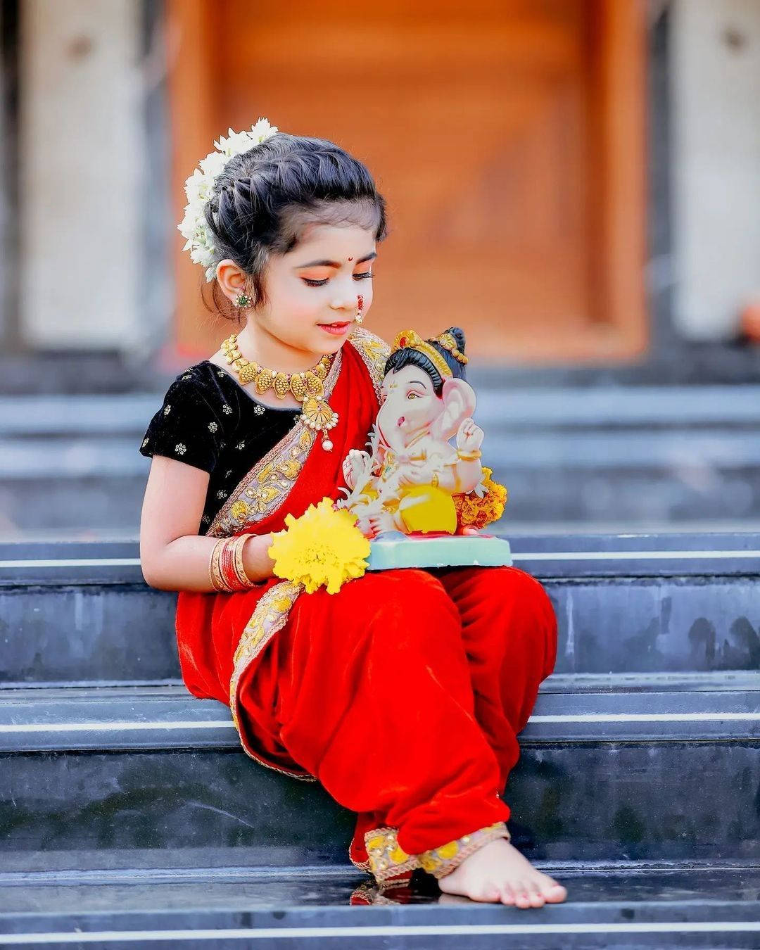 Ganesha idol, vibrant red and black traditional attire, yellow flower, HD Phone Wallpaper