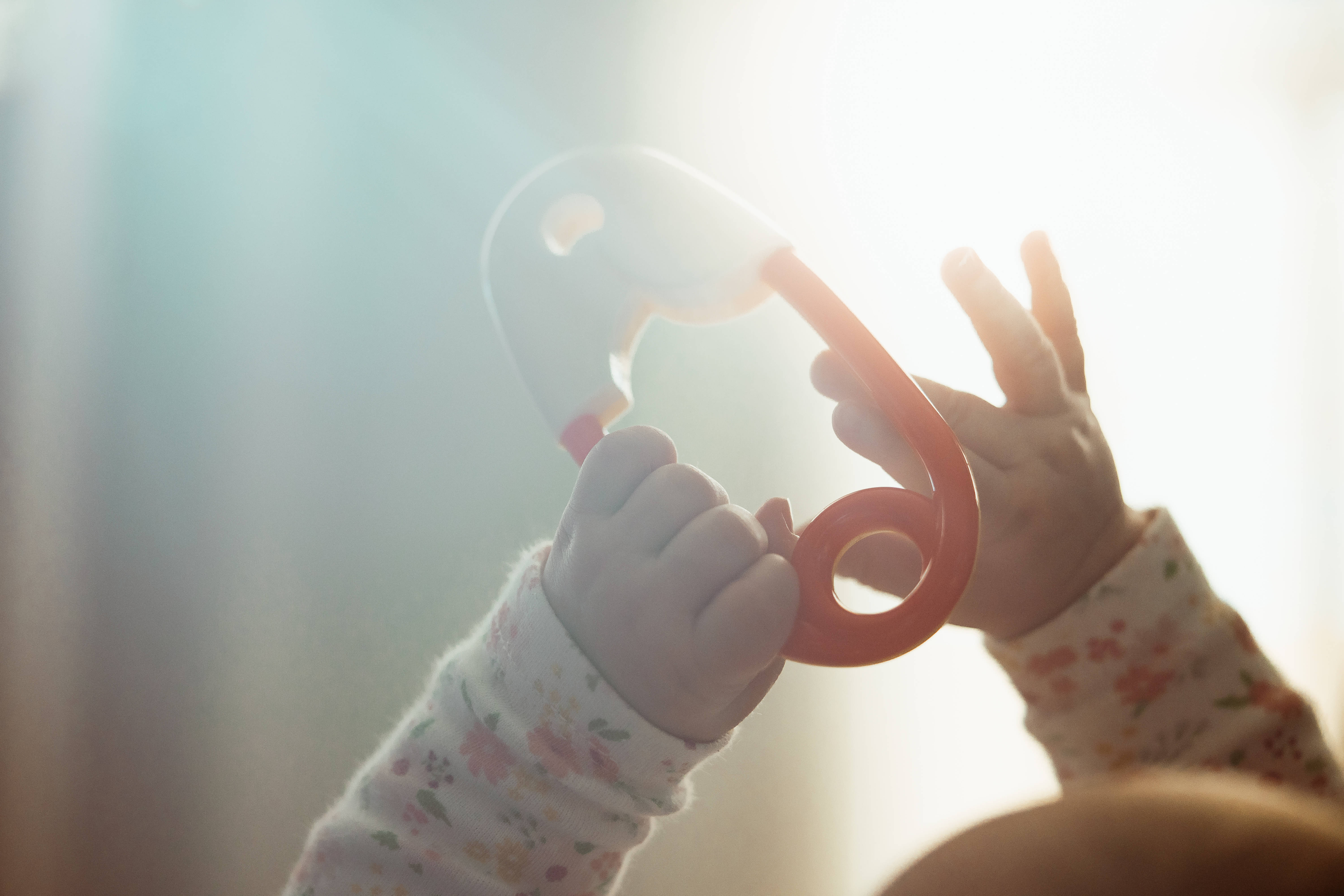 red teether, glowing sunlit window, soft floral sleeves, 5K Desktop Wallpaper