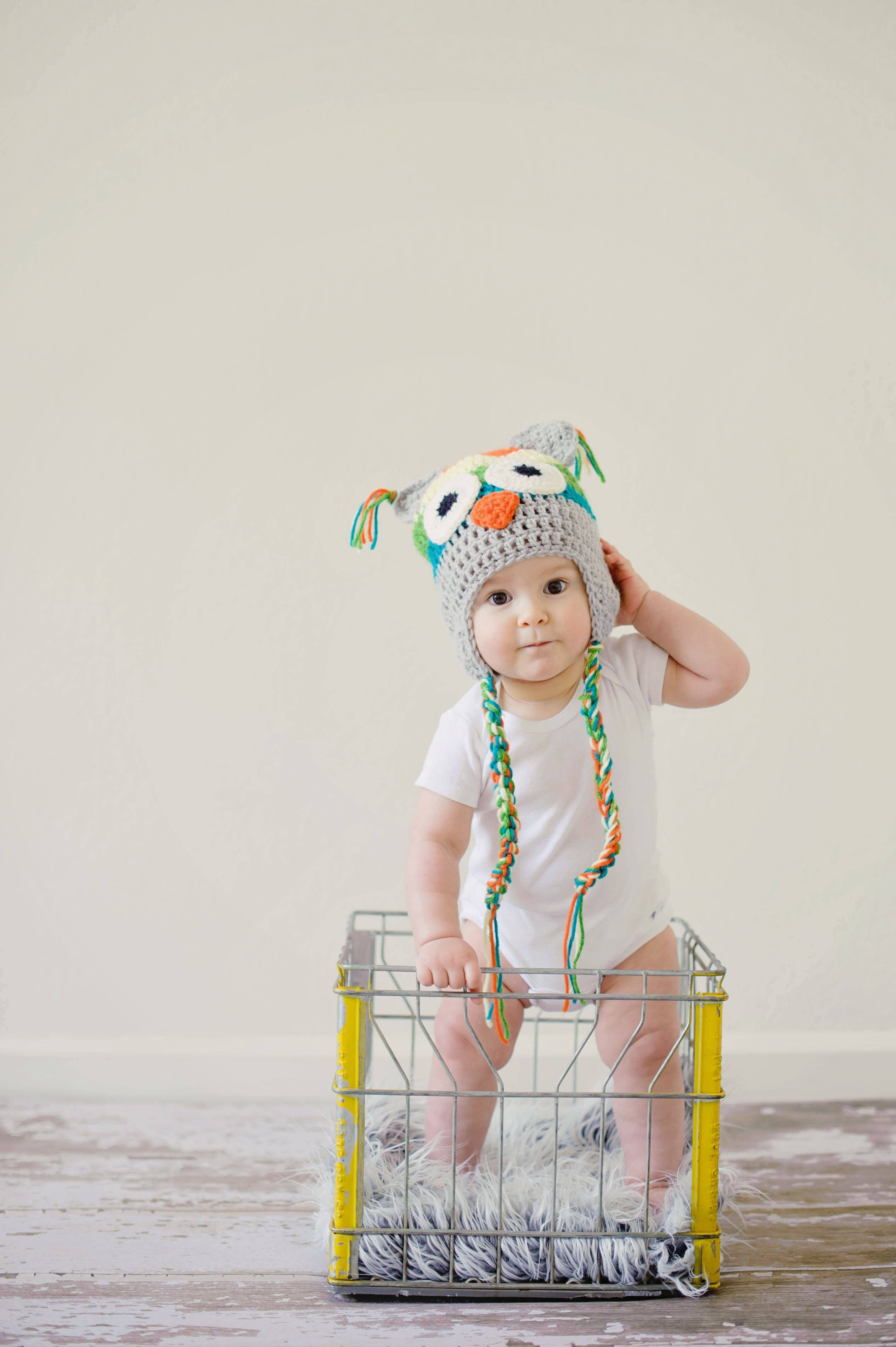 baby, colorful crocheted owl hat, yellow metal crate, 2K Phone Wallpaper