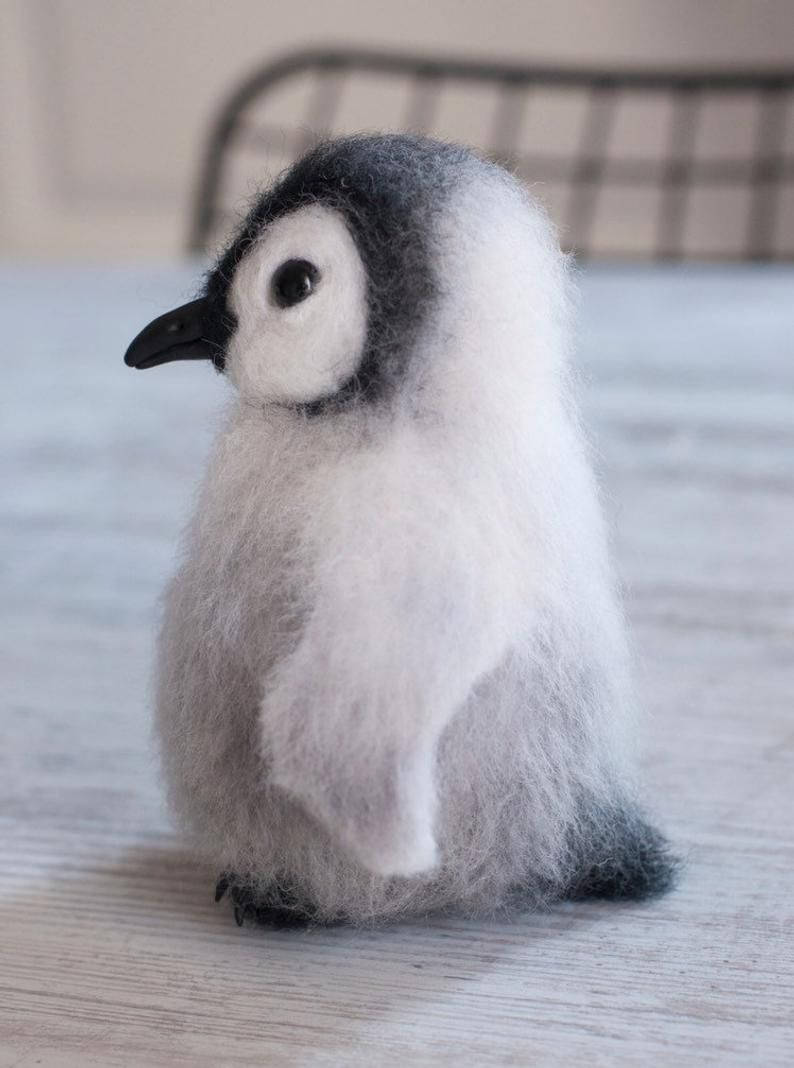 cute baby penguin toy, fluffy needle-felted penguin chick, light wooden surface, SD Phone Wallpaper