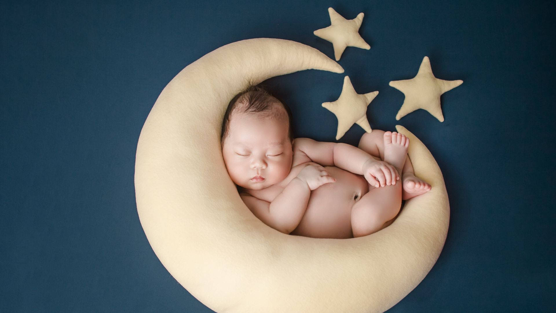 crescent moon-shaped pillow, star decorations, deep blue background, Full HD Desktop Wallpaper