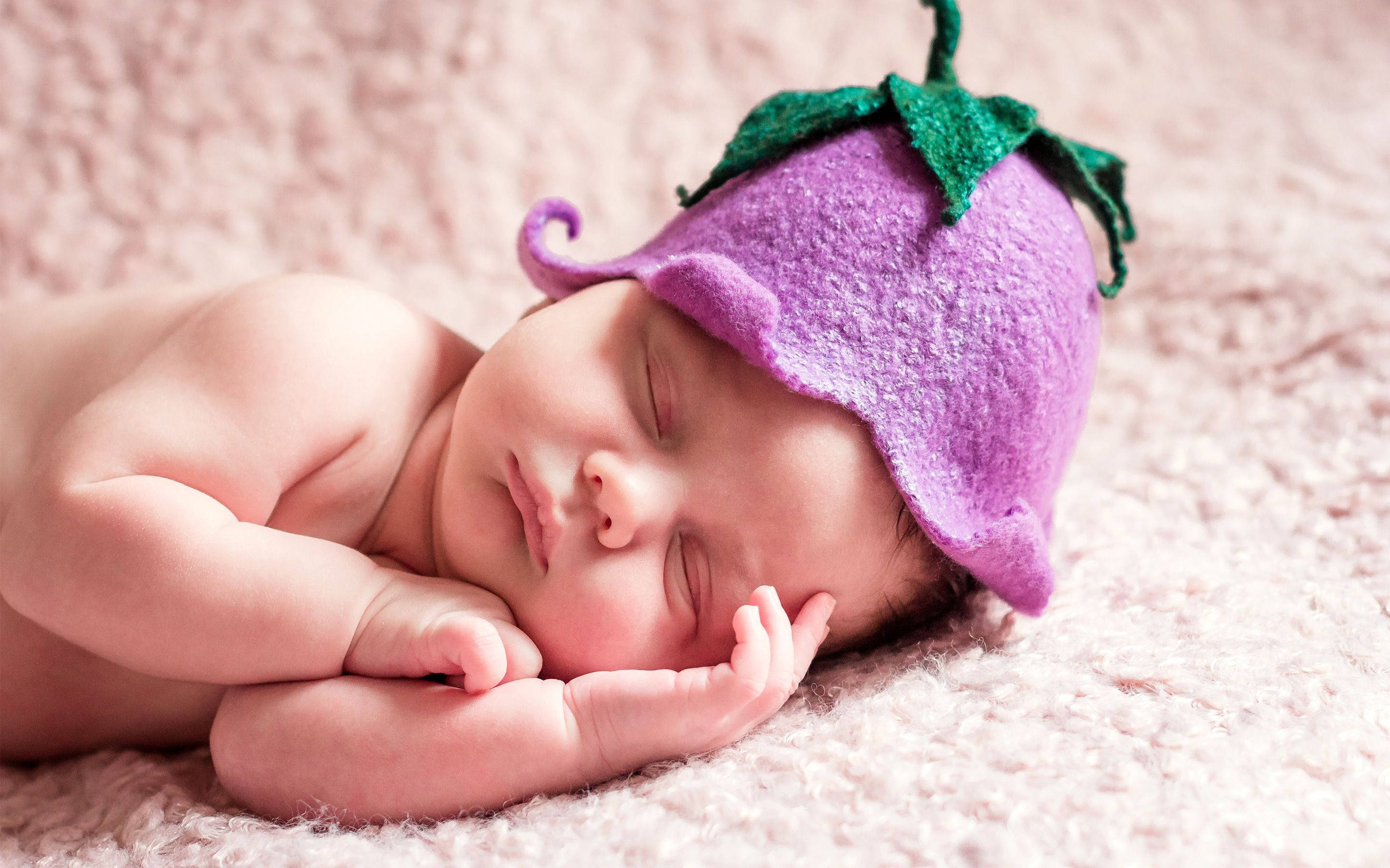 newborn baby, purple felt eggplant hat, soft pink textured blanket, 2K Desktop Wallpaper