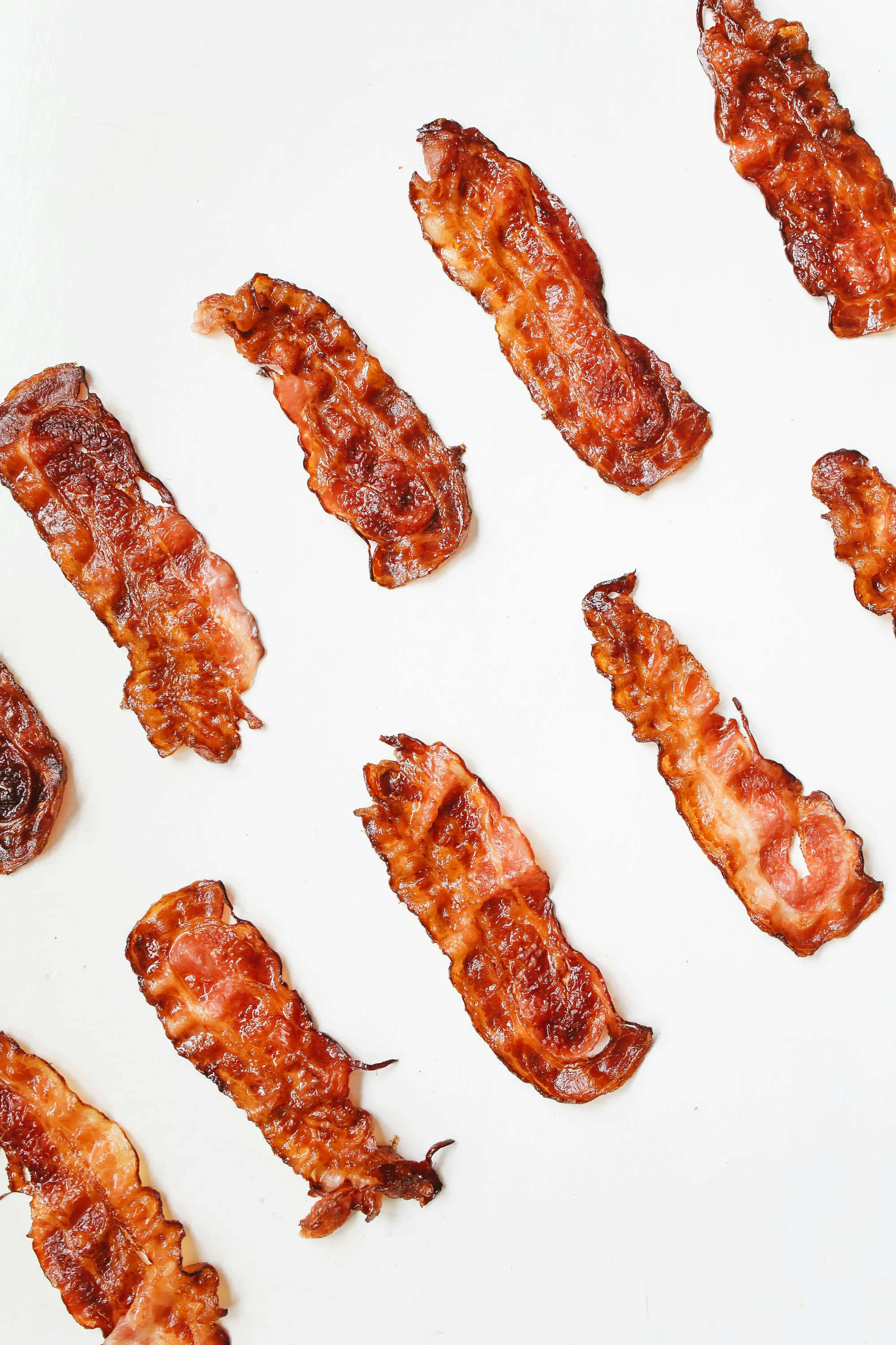 crispy bacon strips, golden-brown, white surface, 2K Phone Wallpaper