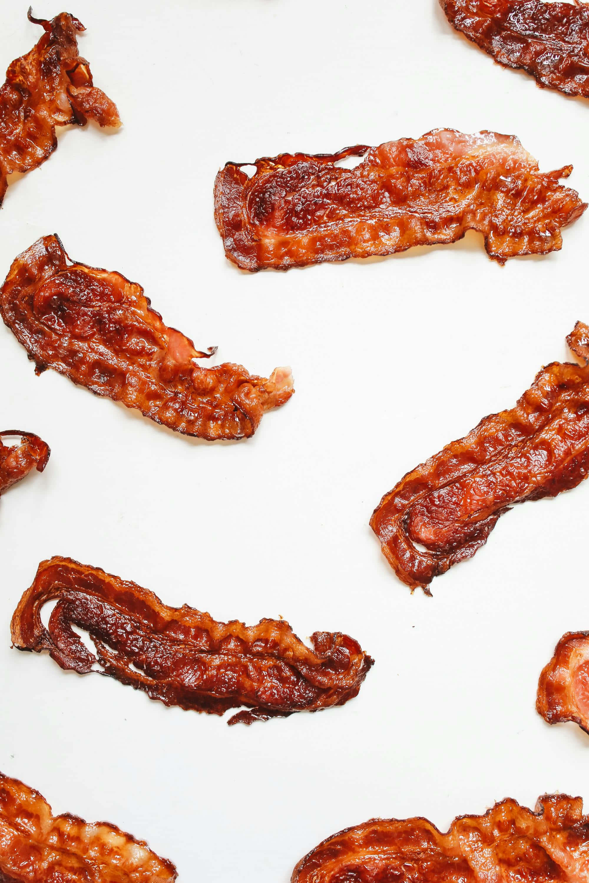 crispy bacon strips, golden-brown, white surface, 2K Phone Wallpaper