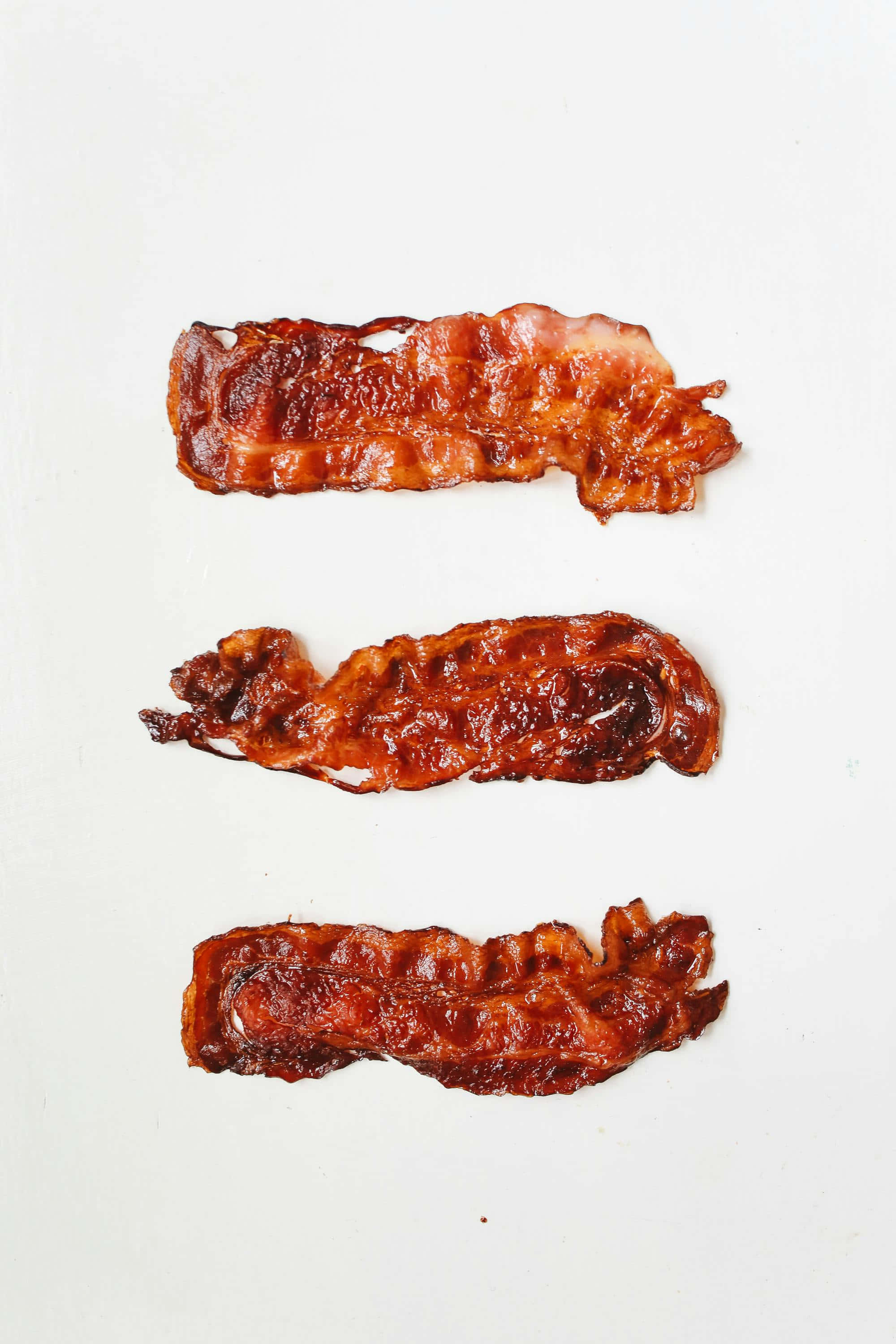 crispy bacon strips, golden-brown, white surface, 2K Phone Wallpaper
