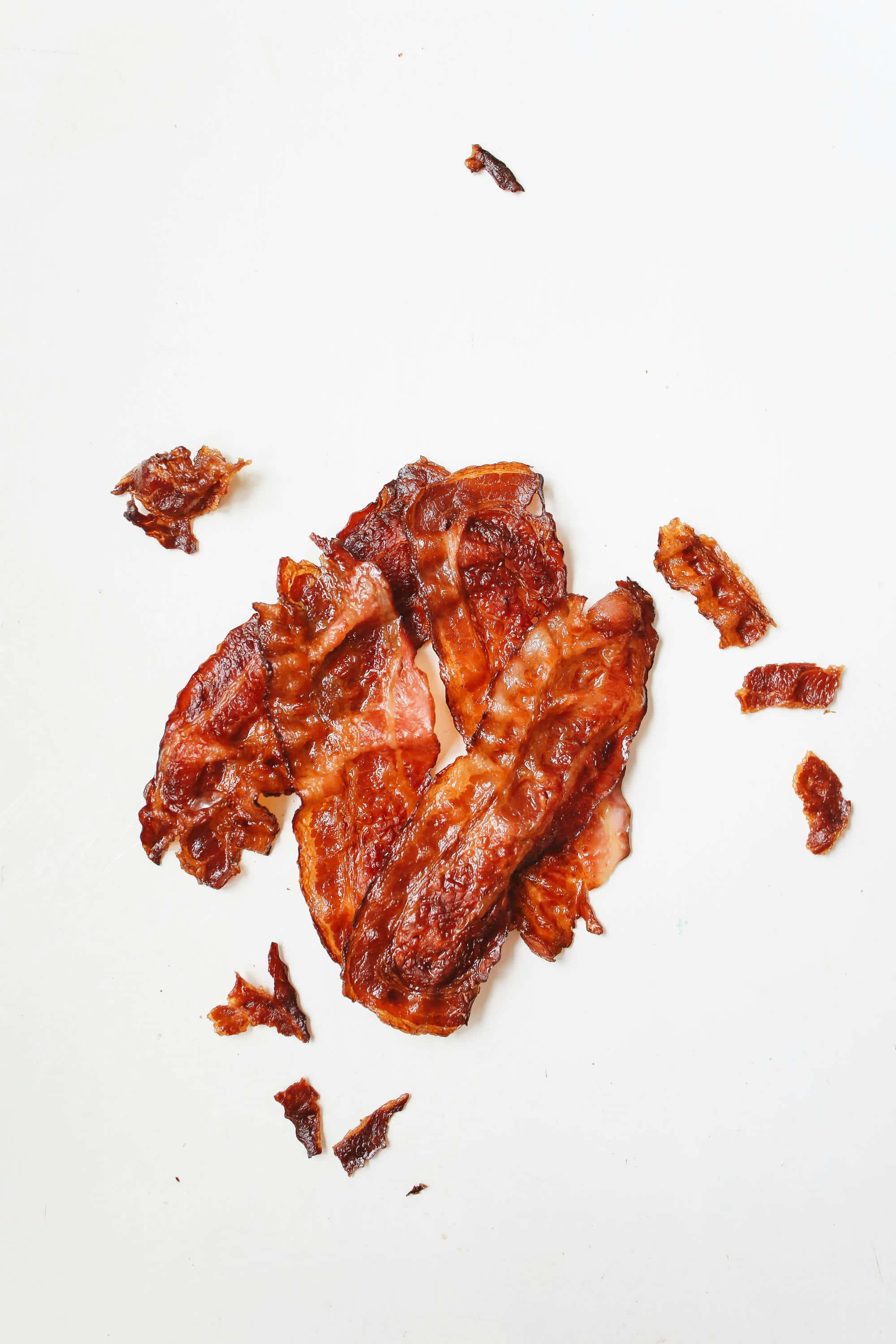 crispy bacon strips, crumbles, stark white surface, 2K Phone Wallpaper