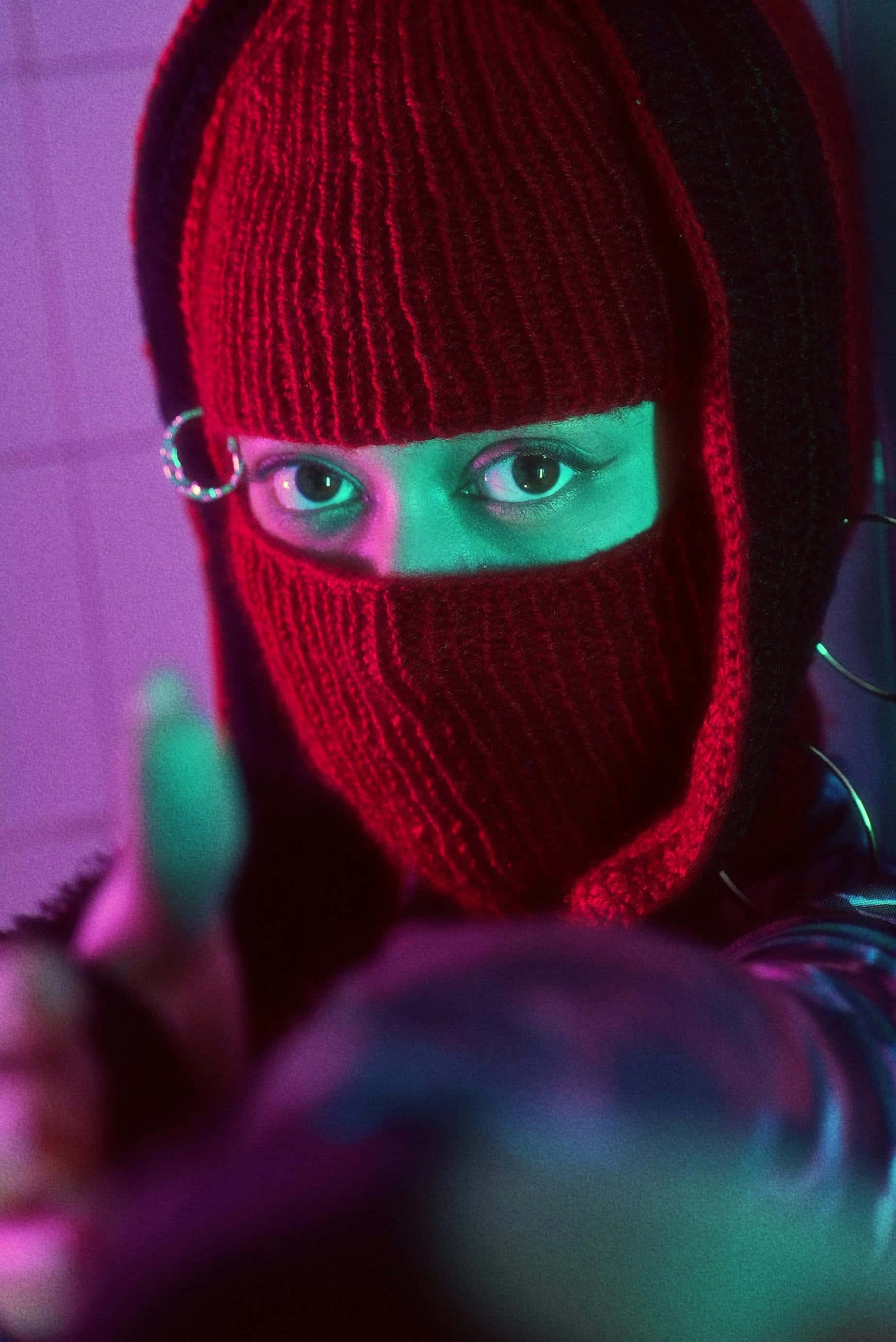 red knit balaclava, glowing green eyes, silver hoop earrings, 2K Phone Wallpaper
