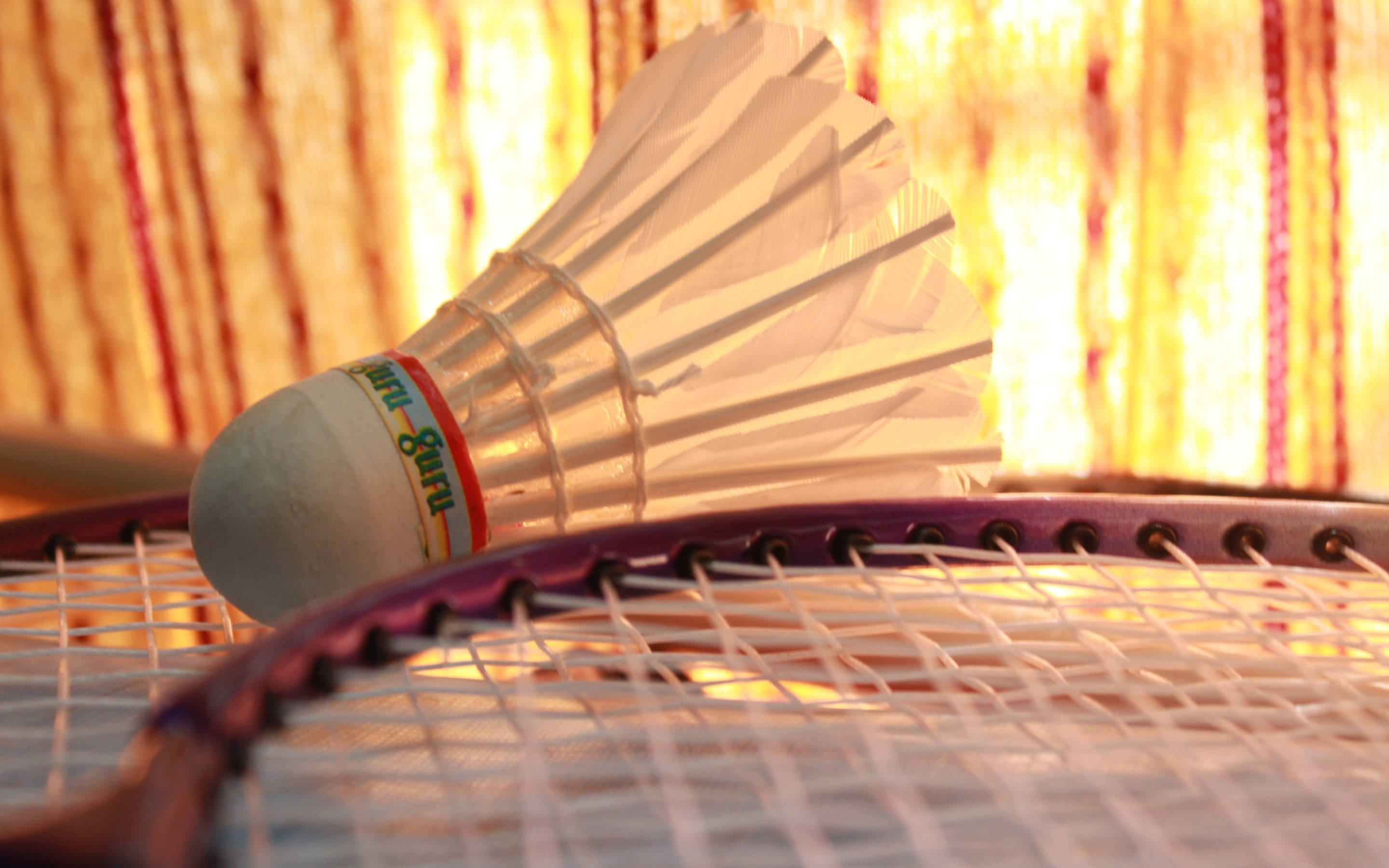 white shuttlecock, purple badminton racket, warm golden striped background, 2K Desktop Wallpaper