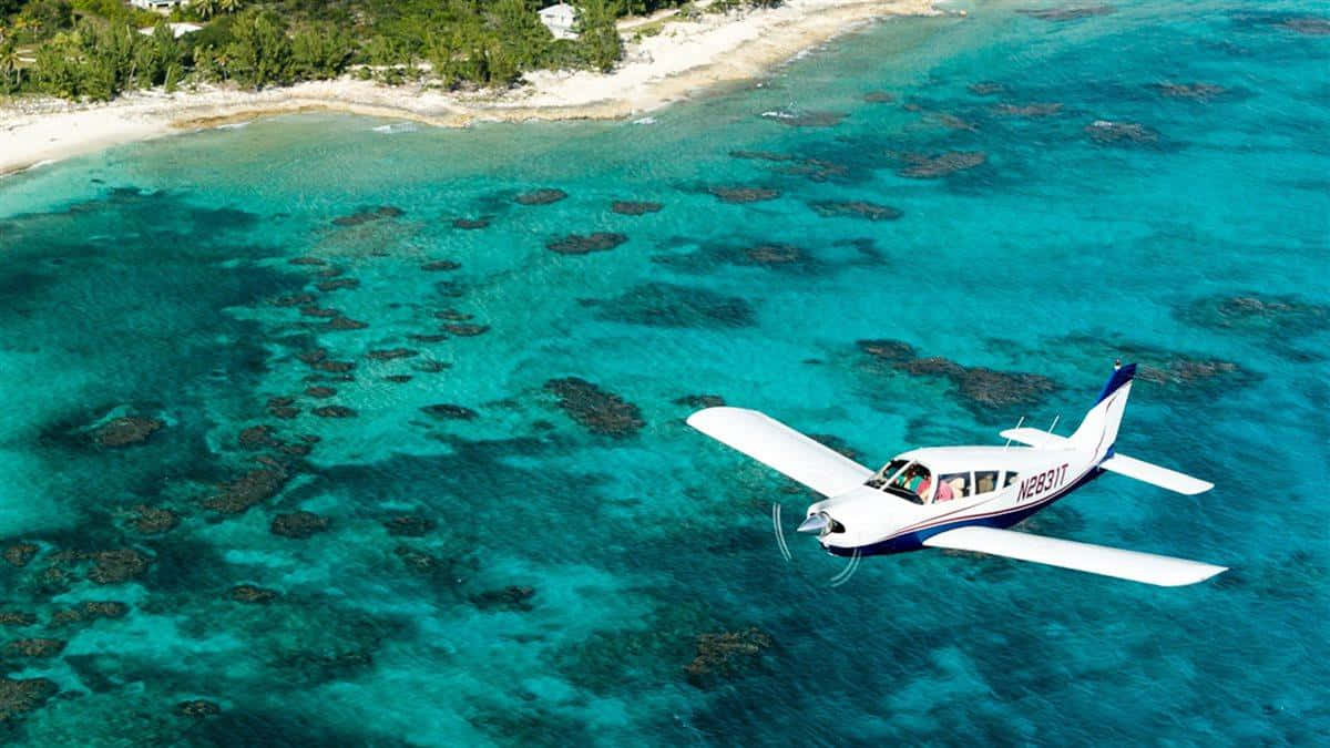 Bahamas Island, white single-engine plane, vibrant turquoise waters, SD Desktop Wallpaper