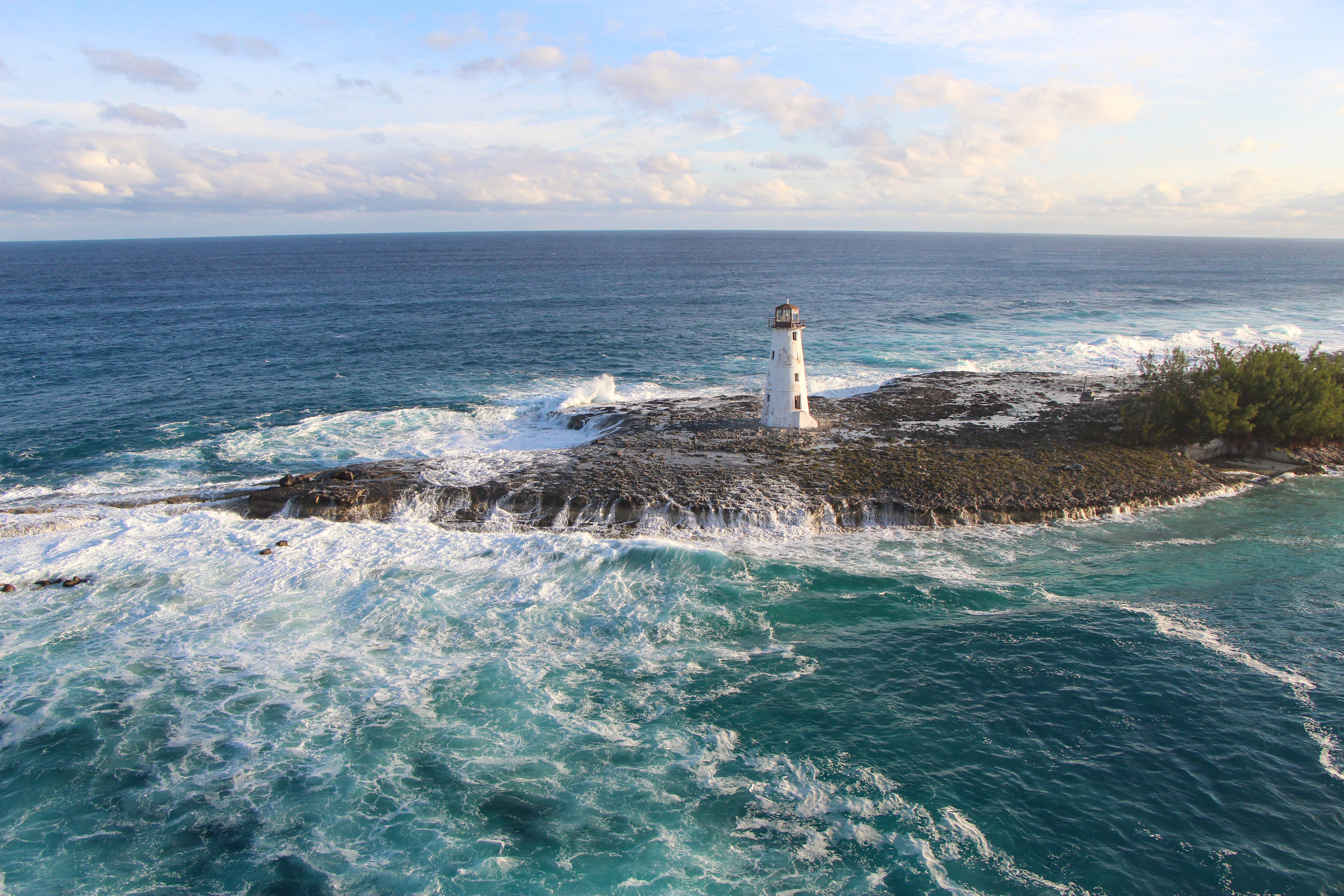 lighthouse, turquoise waves, rocky island, 5K Desktop Wallpaper