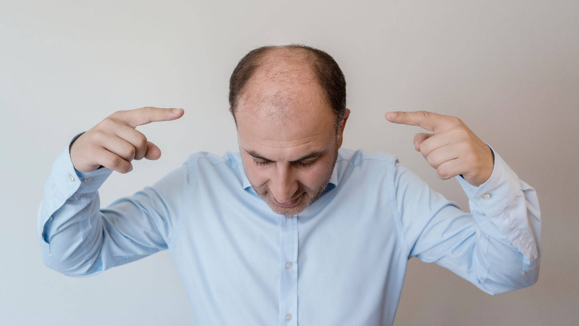 bald man, light blue shirt, index fingers, Full HD Desktop Wallpaper