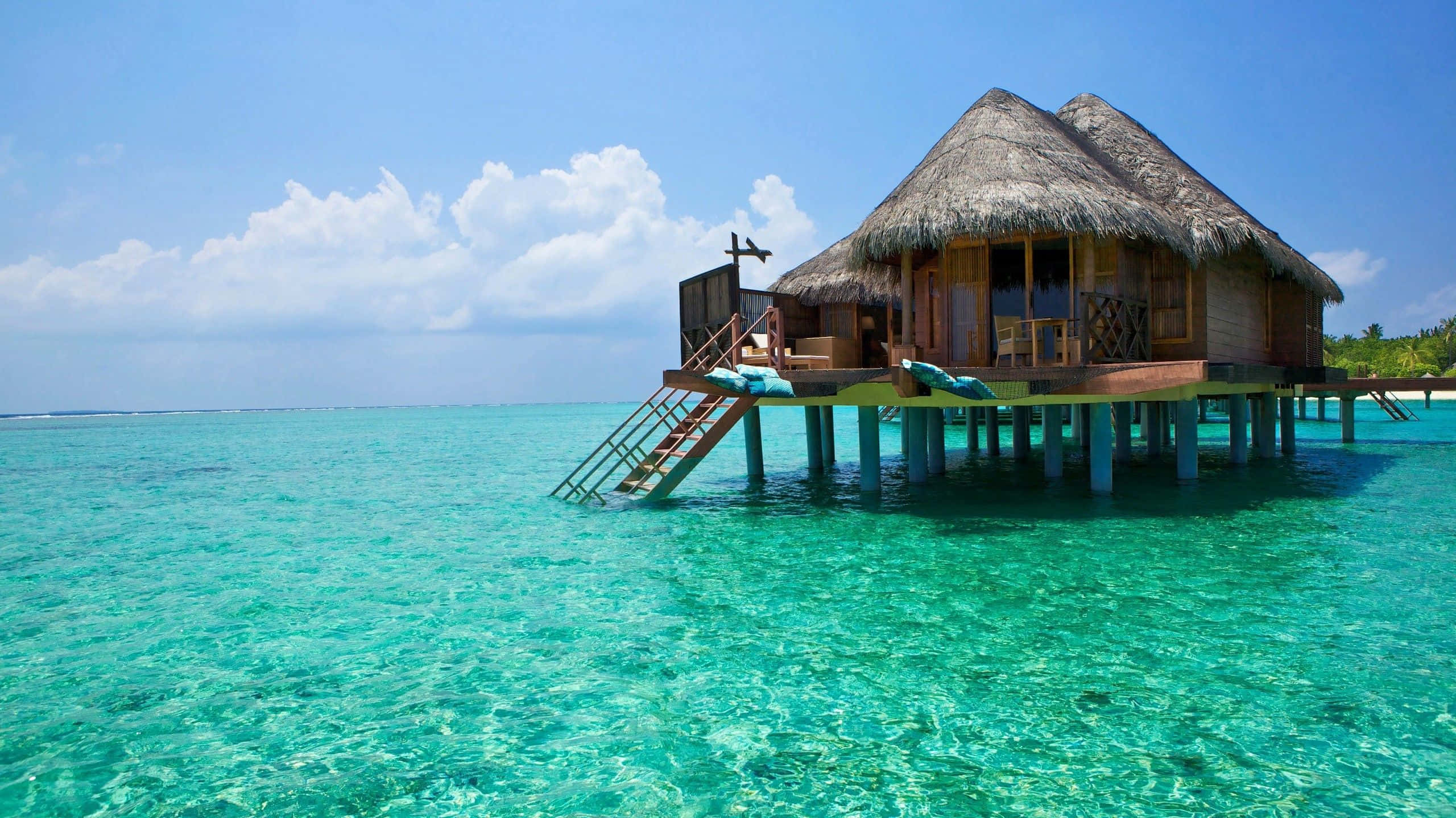 Bali Beach, thatched-roof overwater bungalow, crystal-clear turquoise water, 2K Desktop Wallpaper