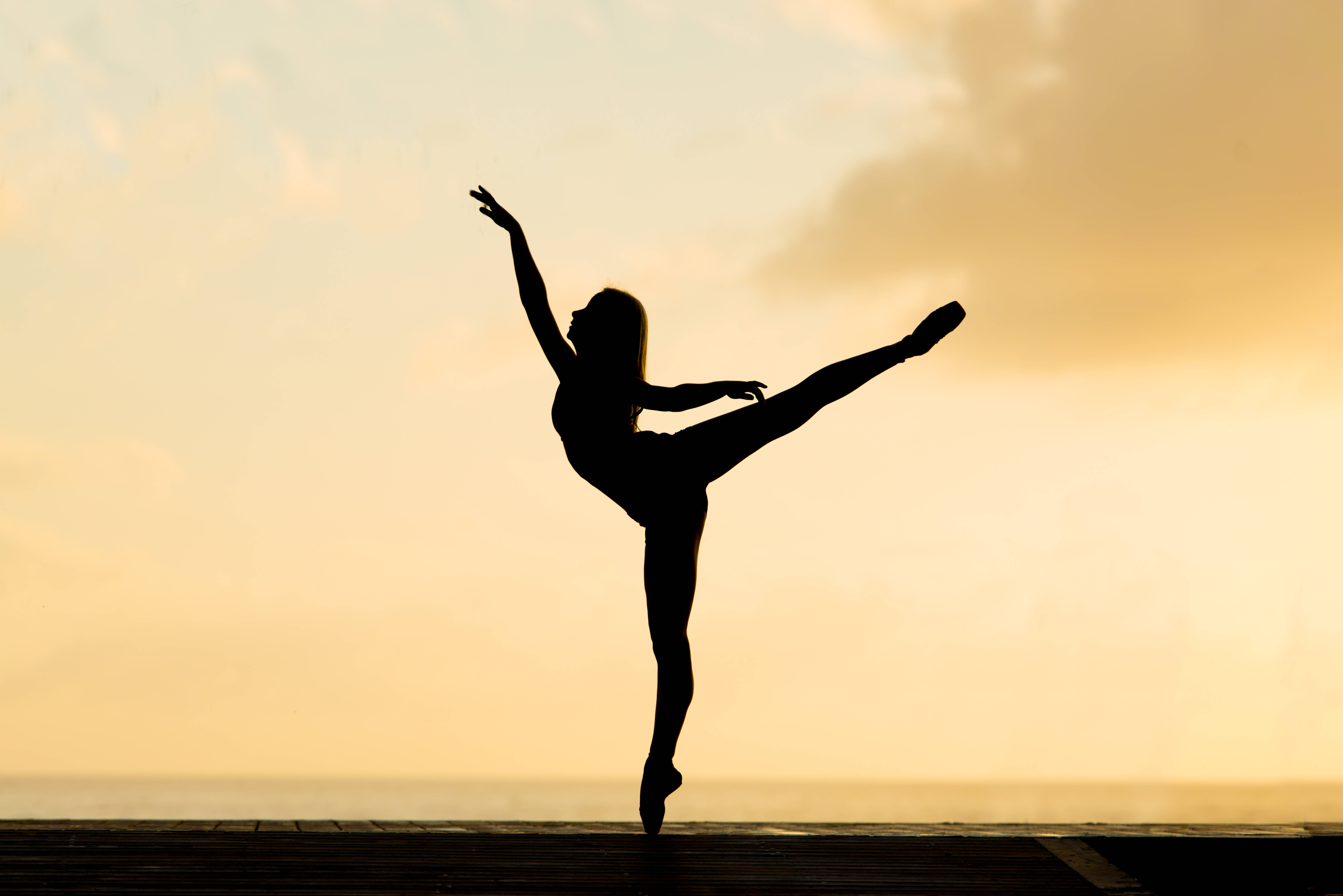 ballet dancer, arabesque pose, golden sunset sky, 5K Desktop Wallpaper
