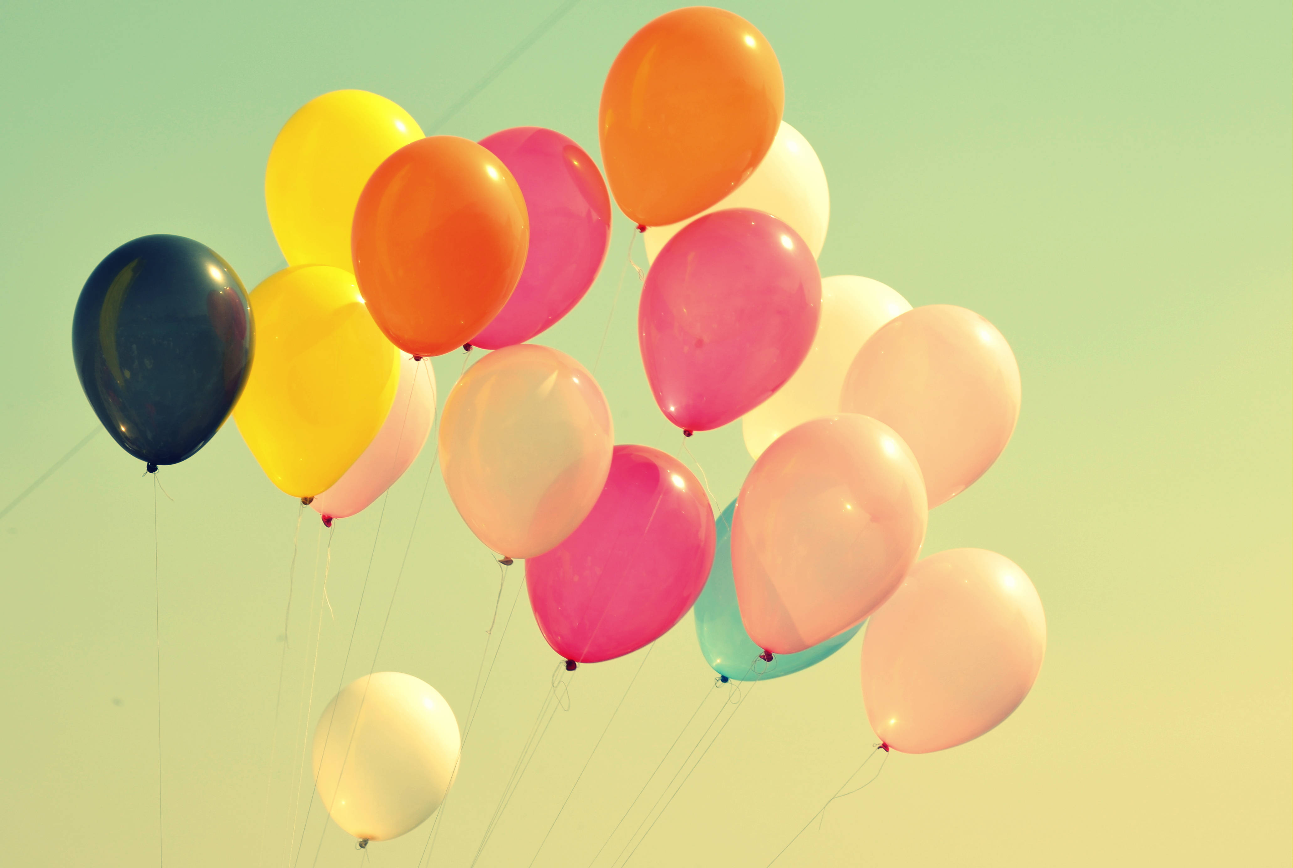 colorful party balloons, soft gradient sky, warm vintage tones, 4K Desktop Wallpaper