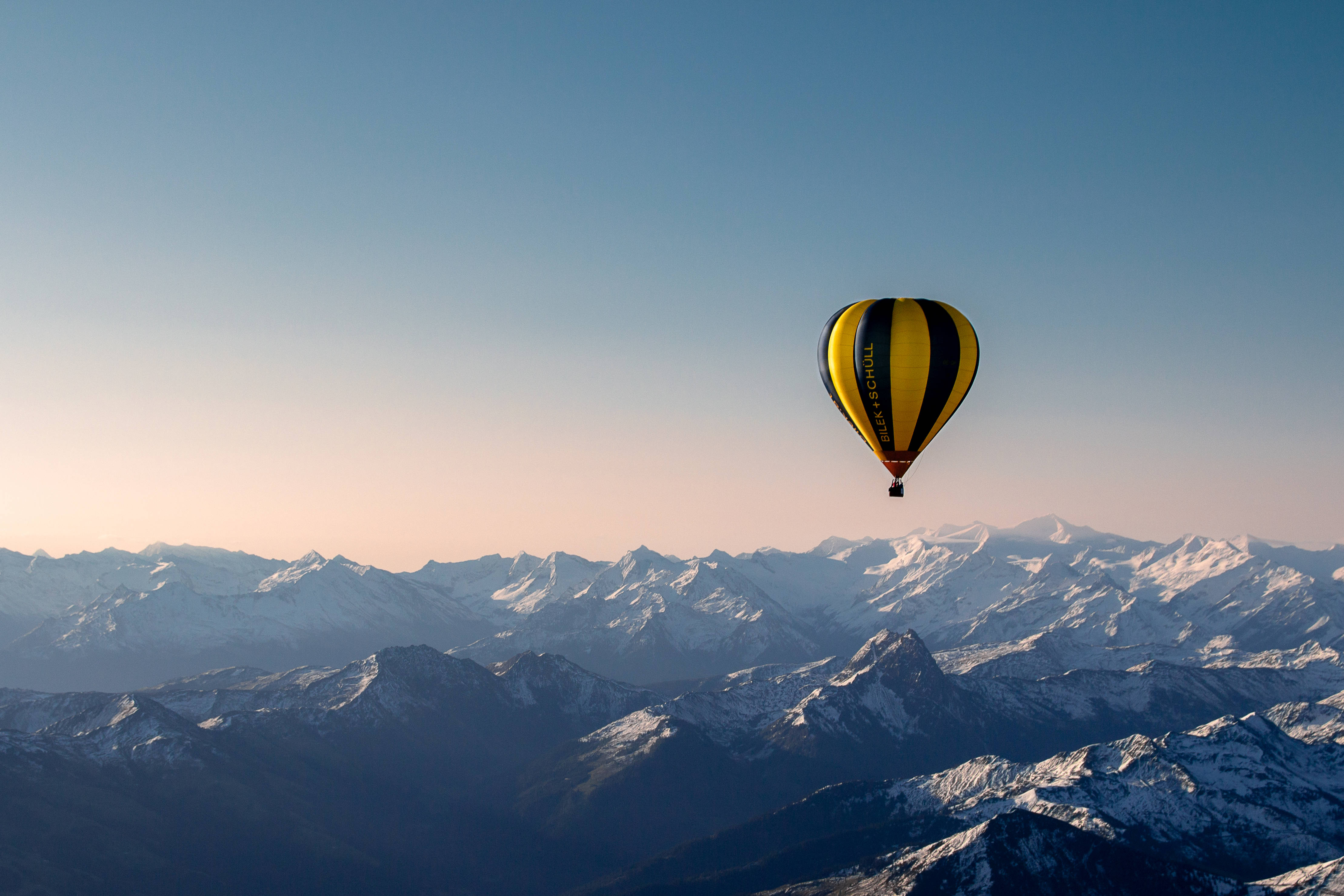 yellow hot air balloon, black hot air balloon, snow capped mountains, 4K Desktop Wallpaper