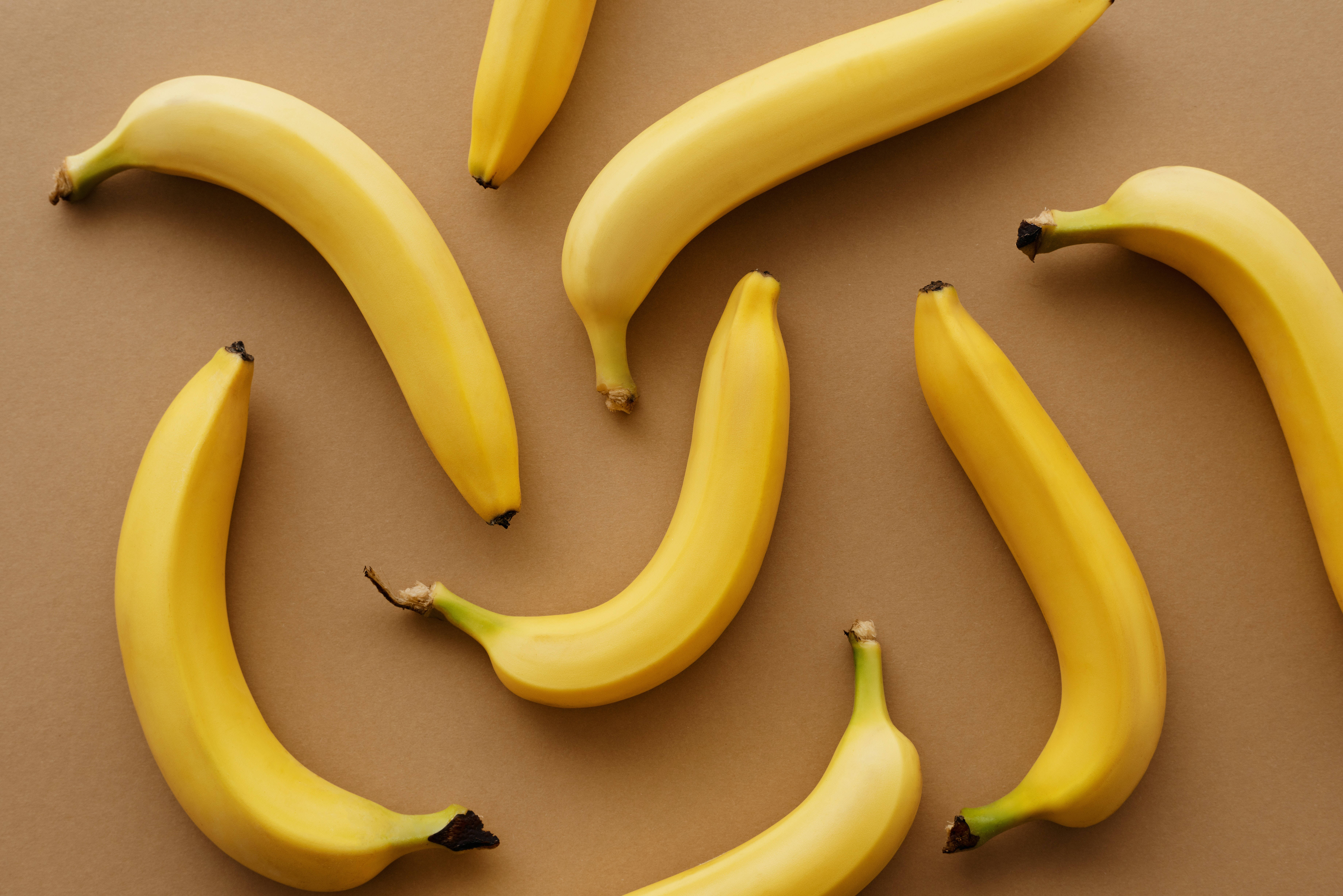 scattered yellow bananas, vibrant yellow bananas, curved pattern, 5K Desktop Wallpaper