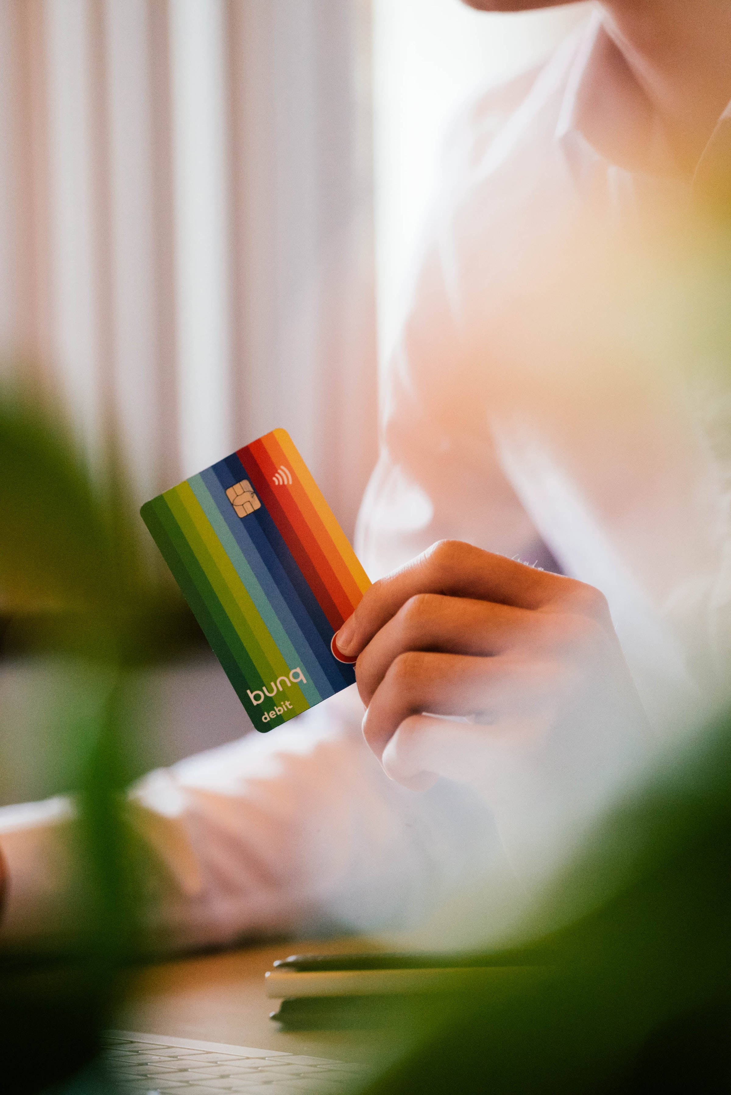 bunq debit card, rainbow-striped, soft natural light, 2K Phone Wallpaper