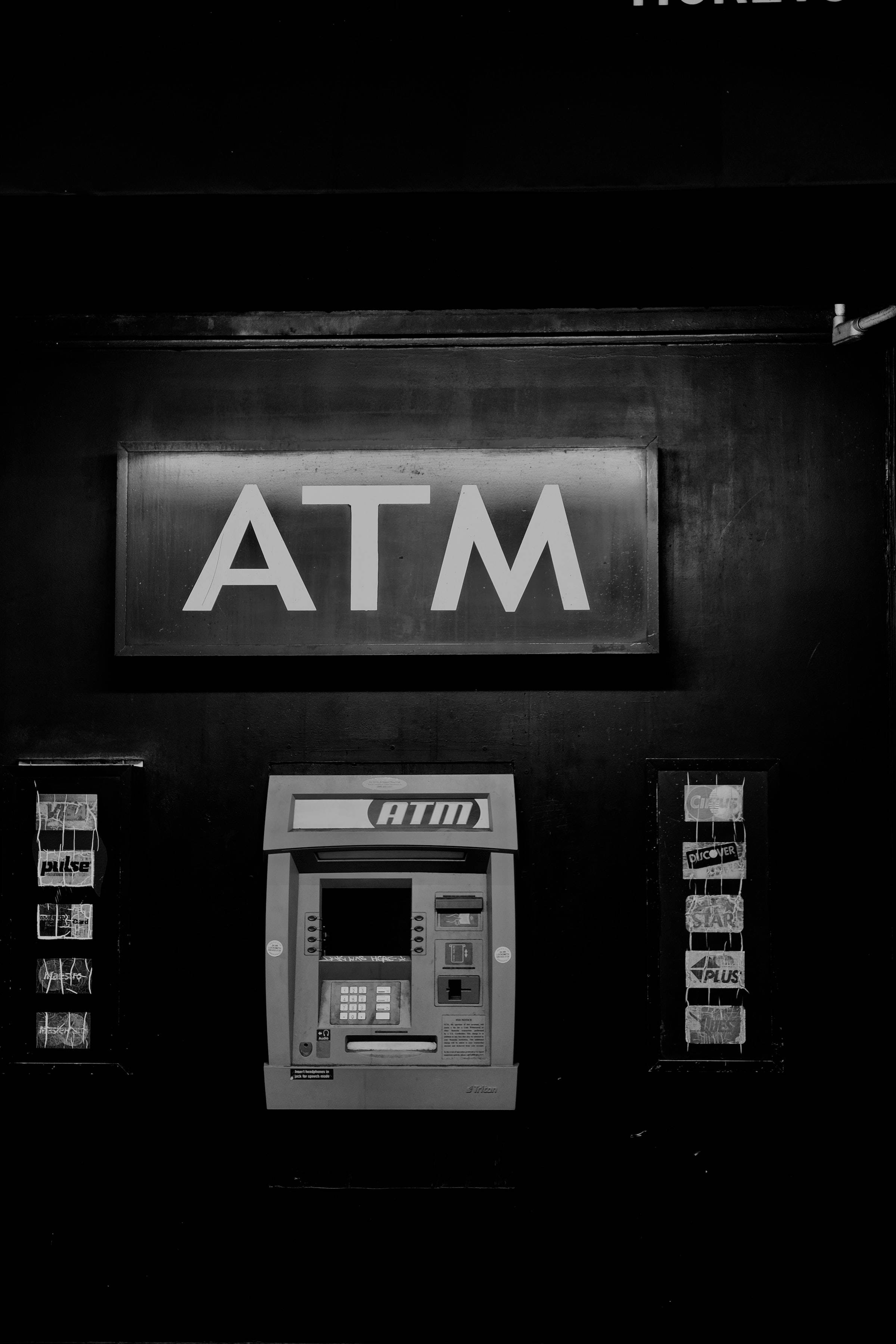 ATM machine, glowing sign, dimly lit space, 2K Phone Wallpaper