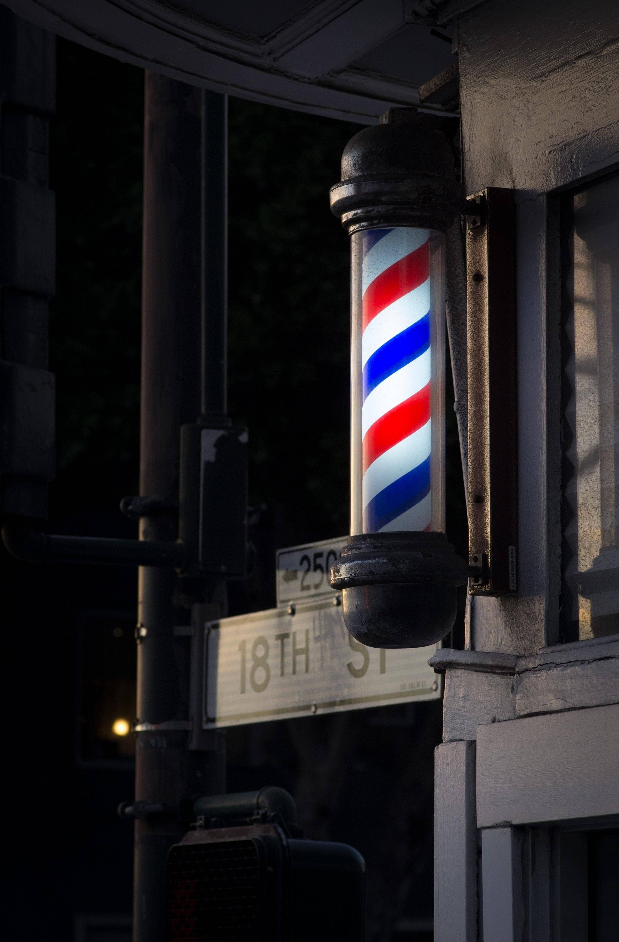 glowing barber pole, red white and blue stripes, dark urban street, 2K Phone Wallpaper