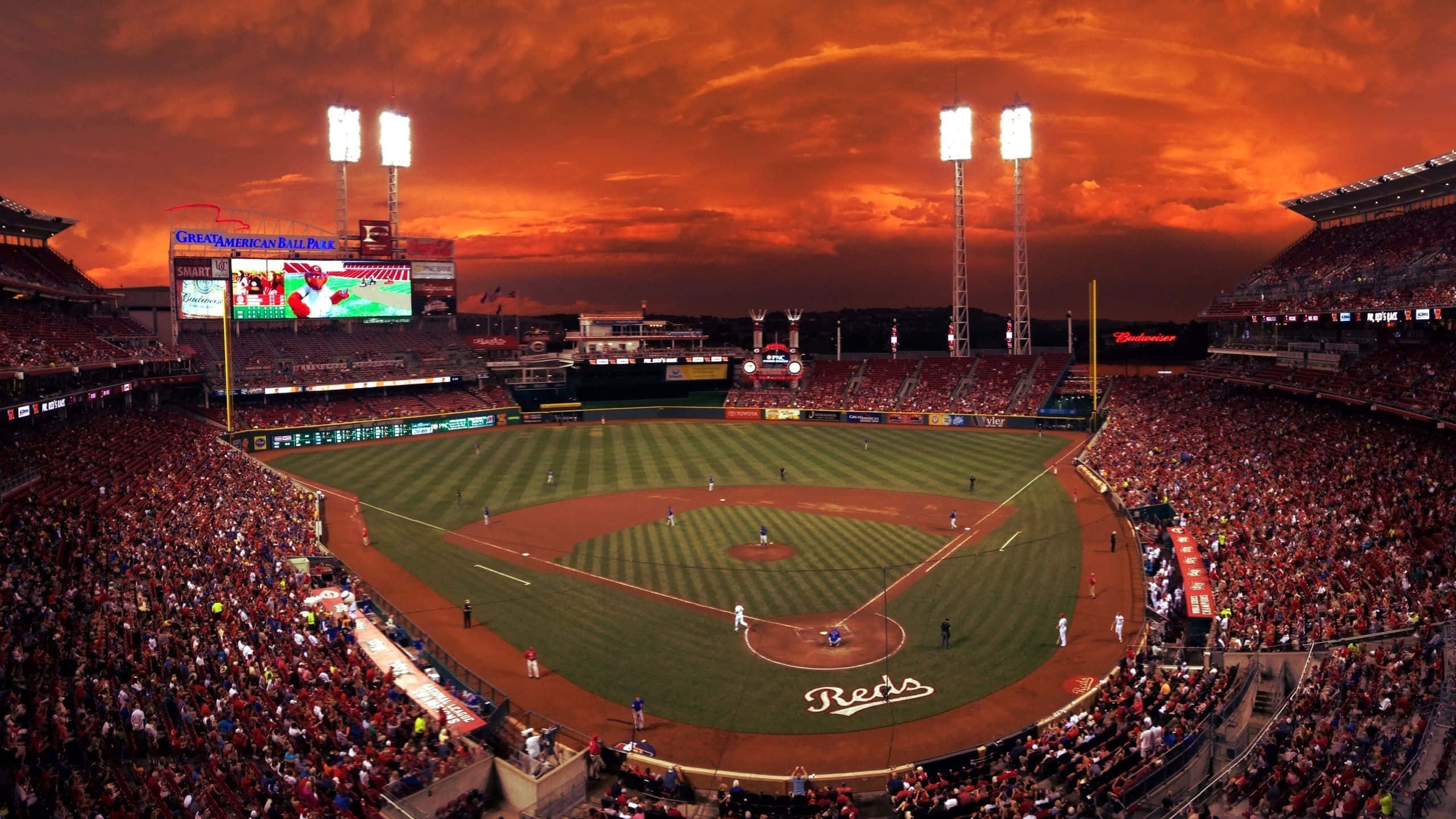 Baseball Stadium, fiery orange sunset sky, glowing floodlights, 2K Desktop Wallpaper
