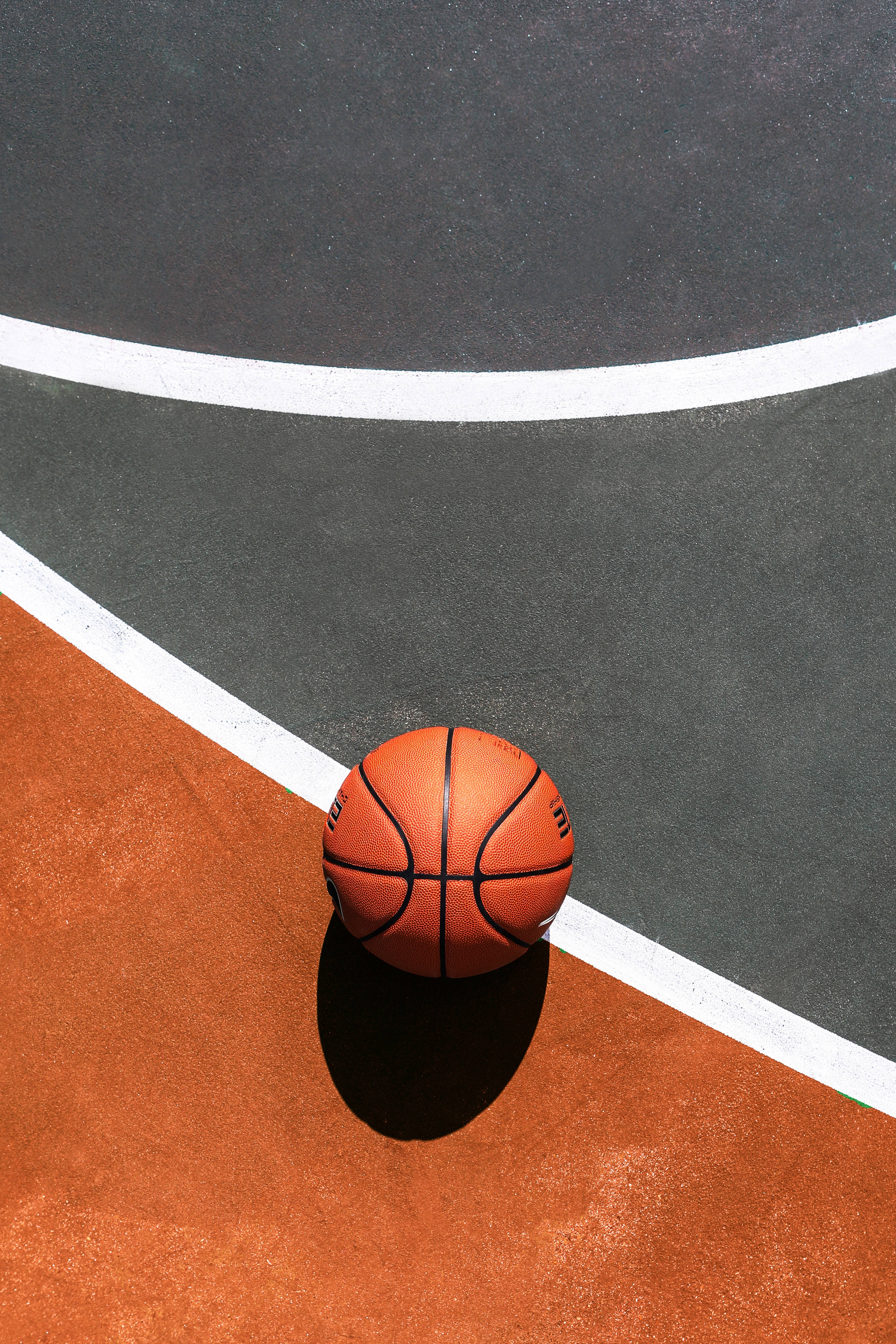 bright orange basketball, sunlit court, crisp white lines, 4K Phone Wallpaper