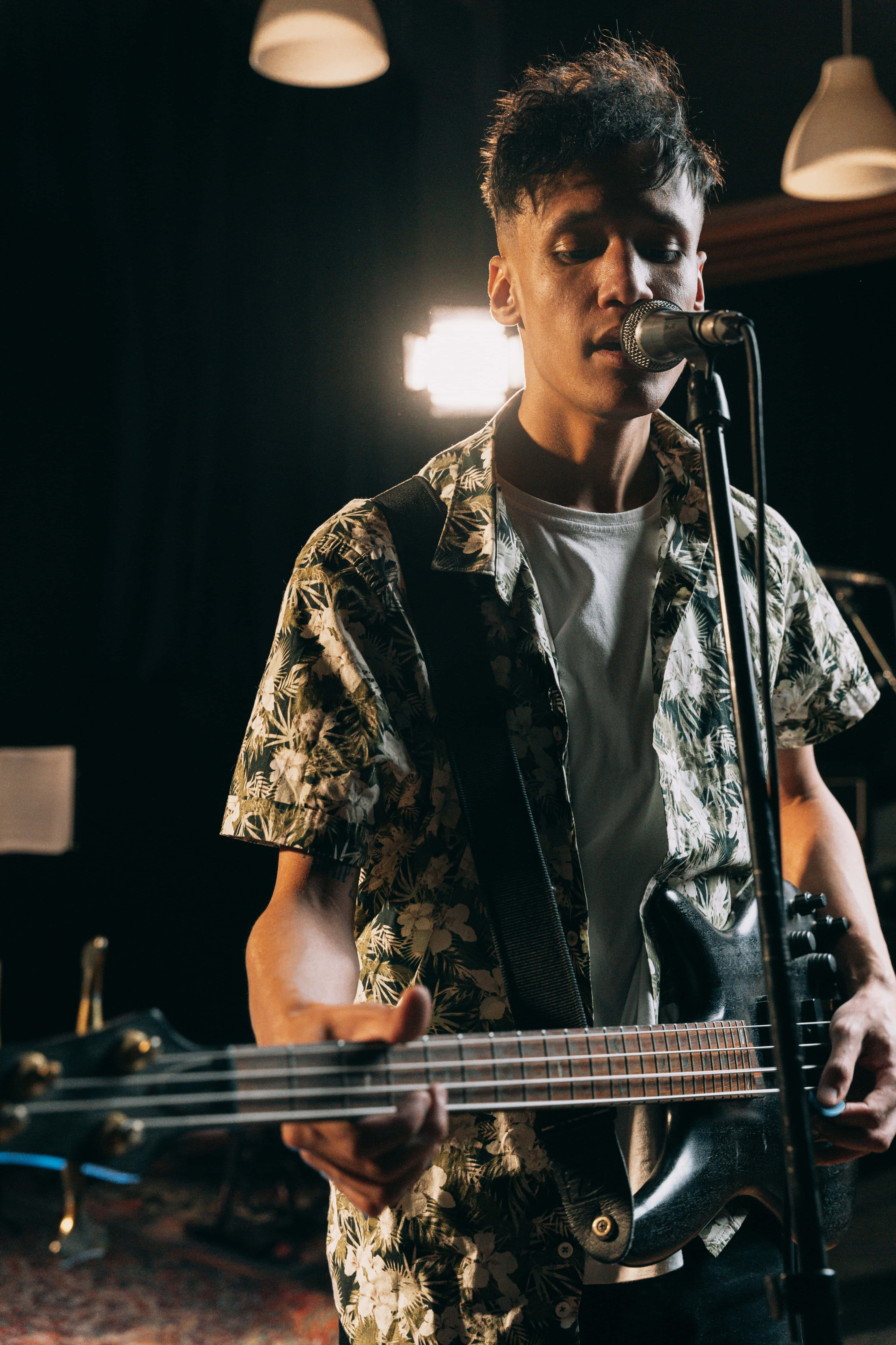 bass guitar, warm stage lights, microphone, 5K Phone Wallpaper