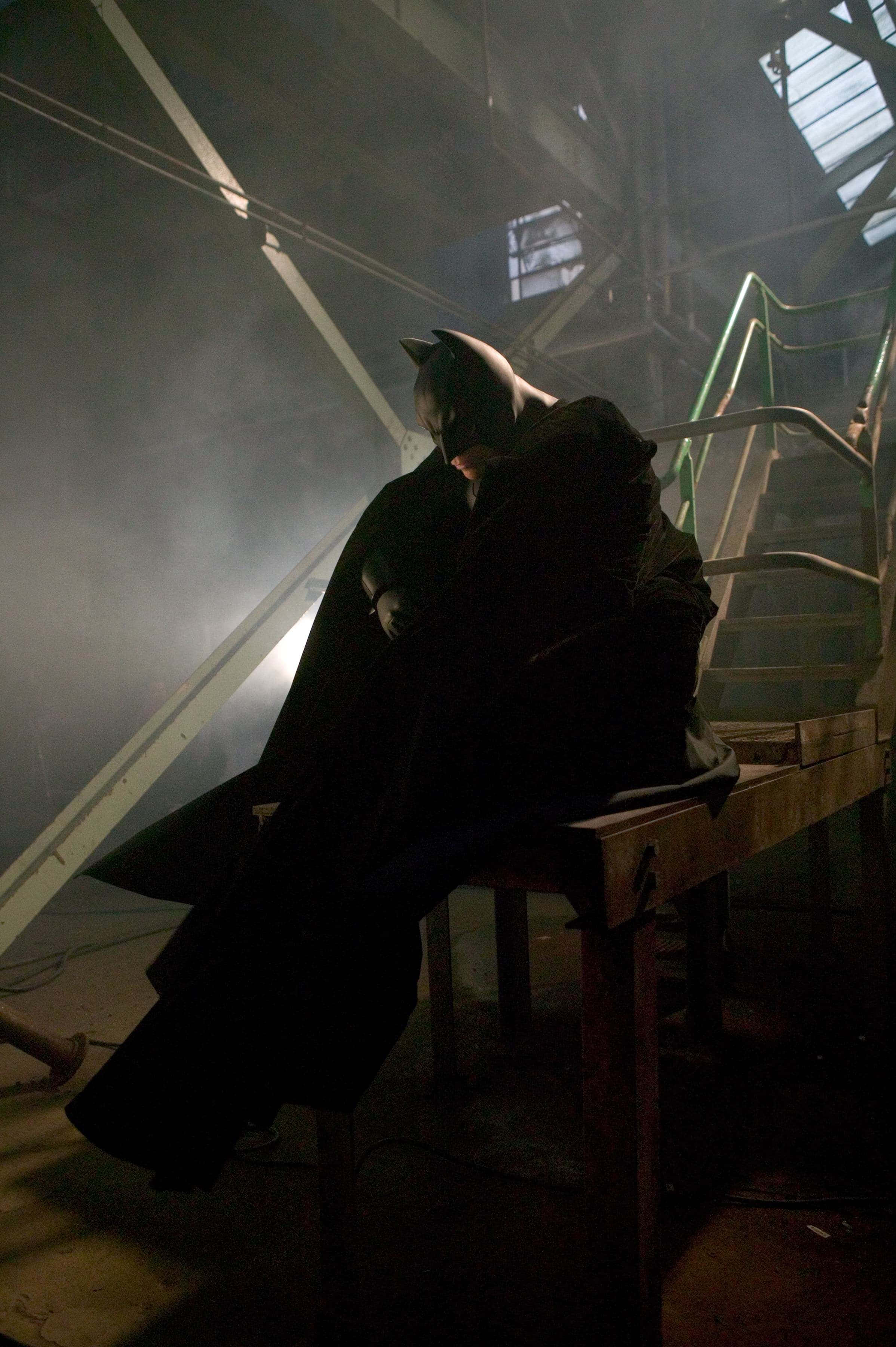 Batman Begins, dim industrial space, dramatic backlighting, 2K Phone Wallpaper