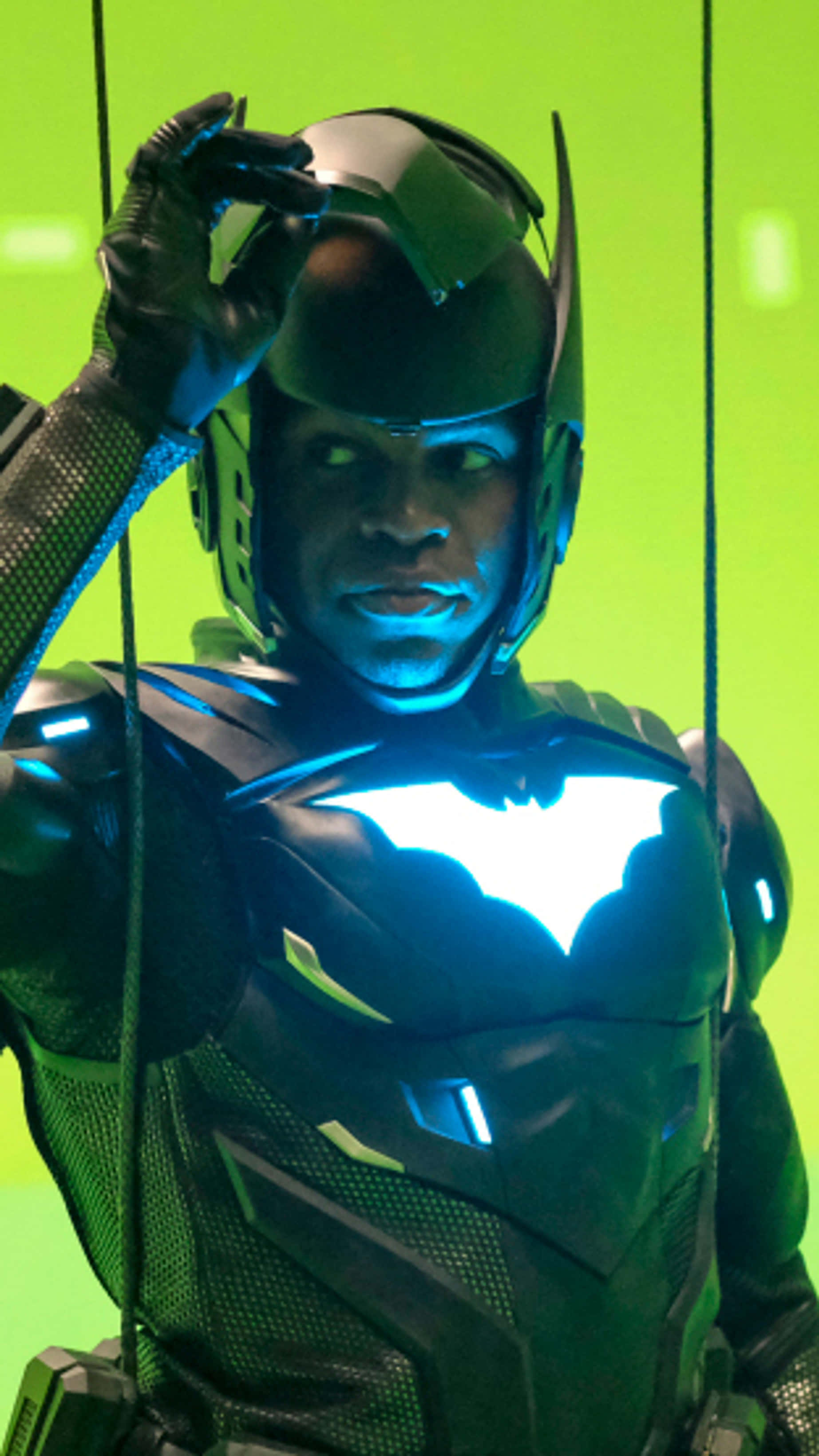 Batwing, sleek black armored suit, glowing blue bat emblem, 2K Phone Wallpaper