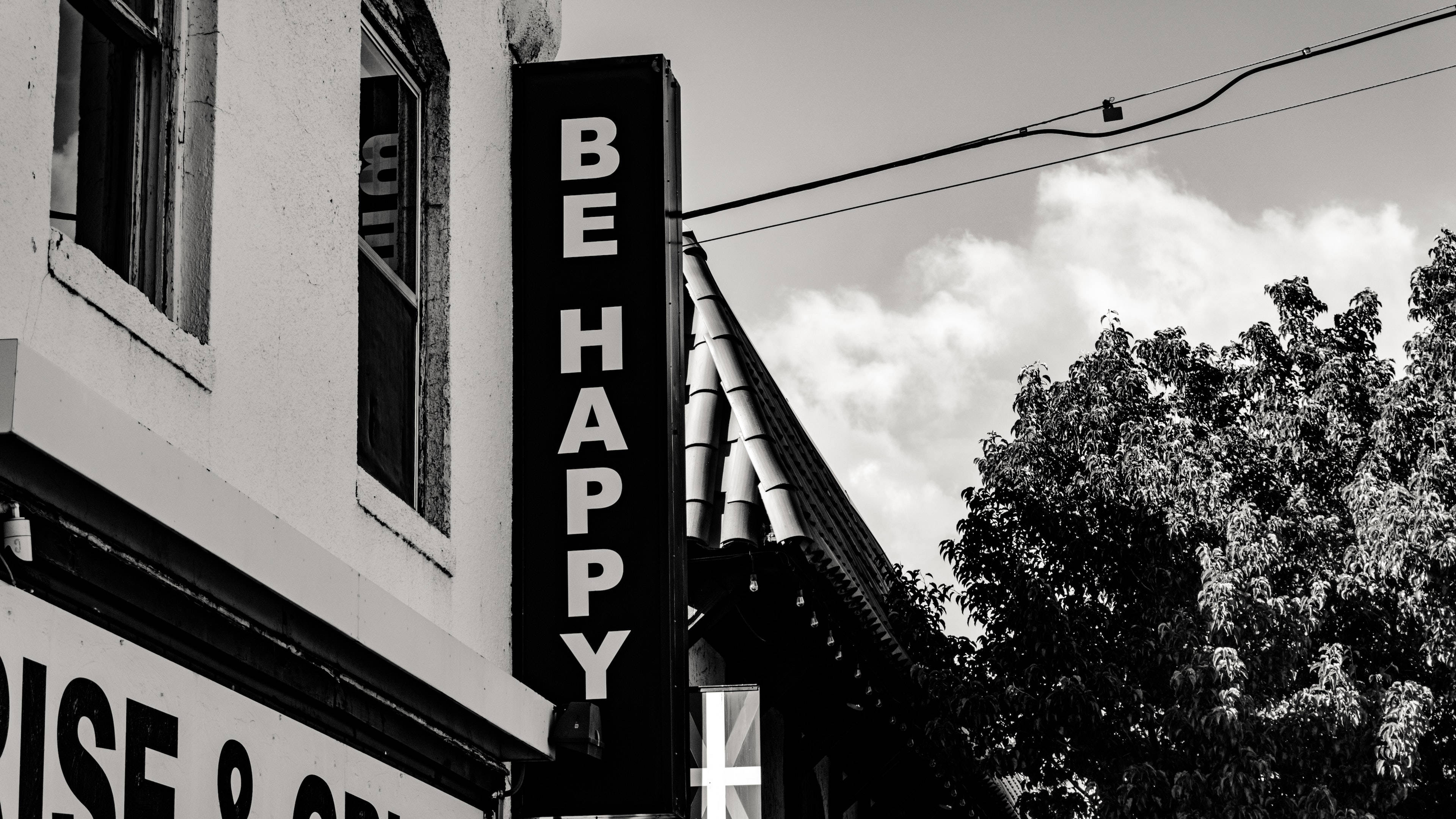 BE HAPPY, black and white urban street scene, vertical 'BE HAPPY' sign, 4K Desktop Wallpaper