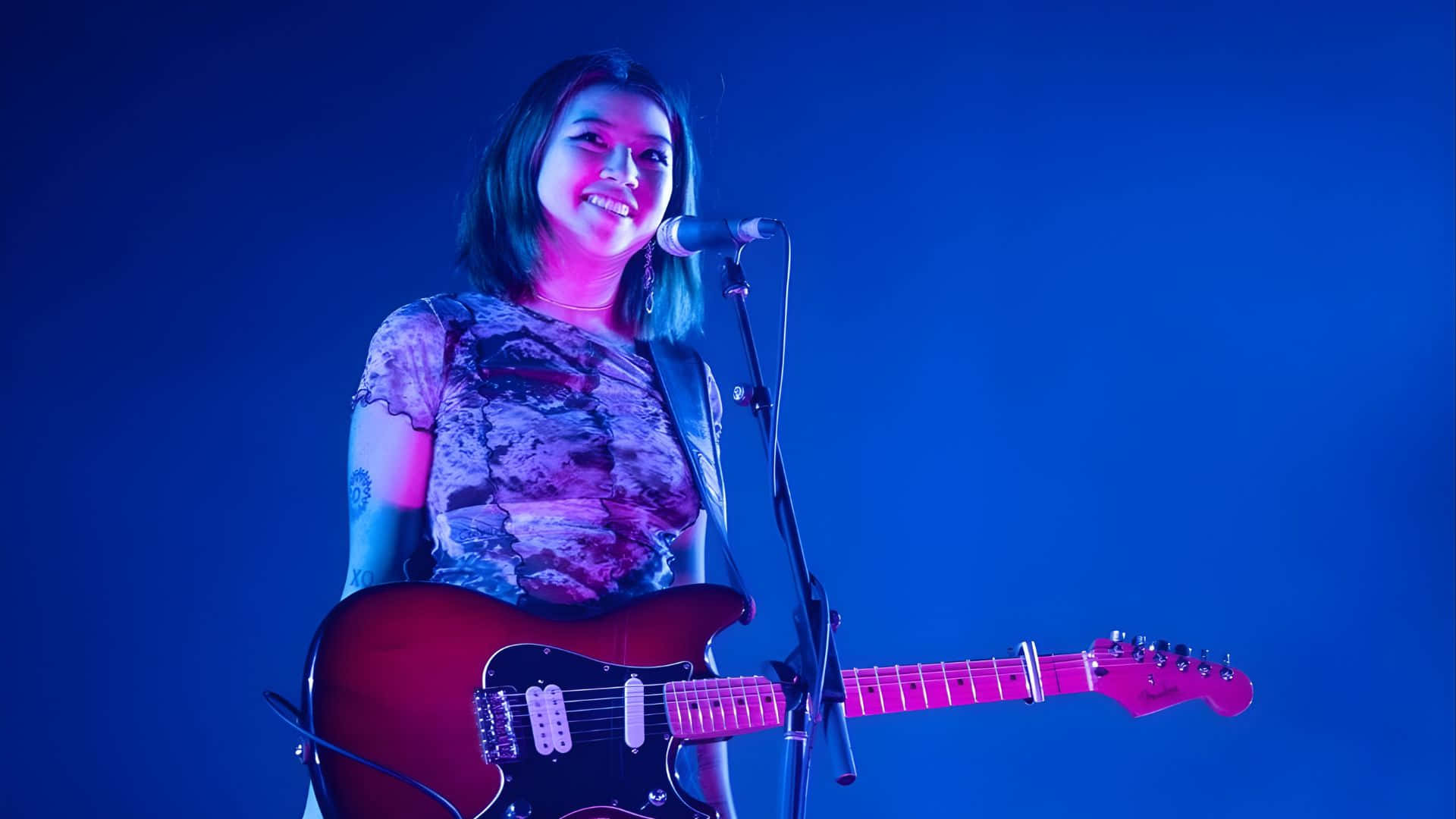 Beabadoobee, red electric guitar, vibrant blue and pink stage lights, Full HD Desktop Wallpaper