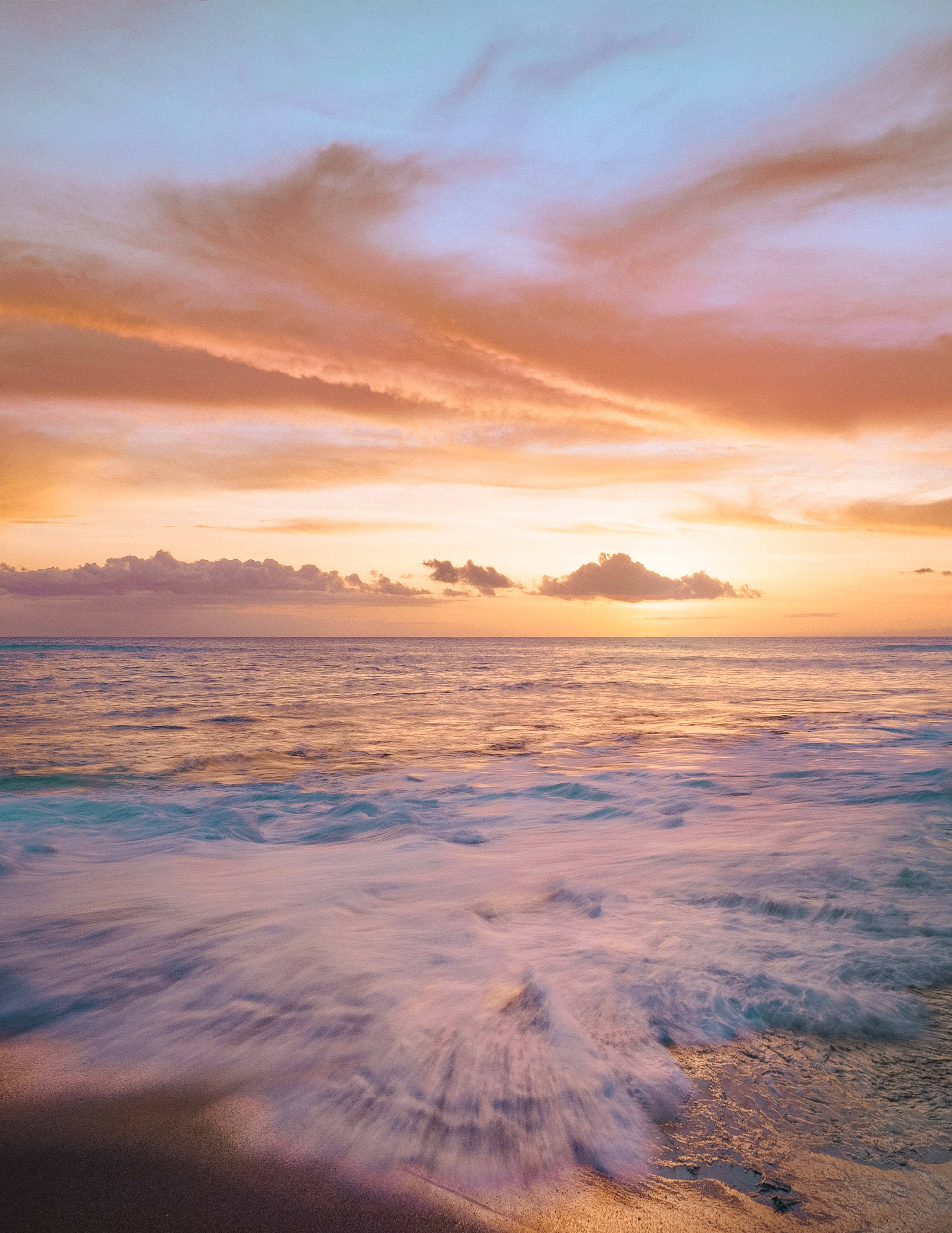 Sunset, warm oranges and pinks, gentle waves, 5K Phone Wallpaper