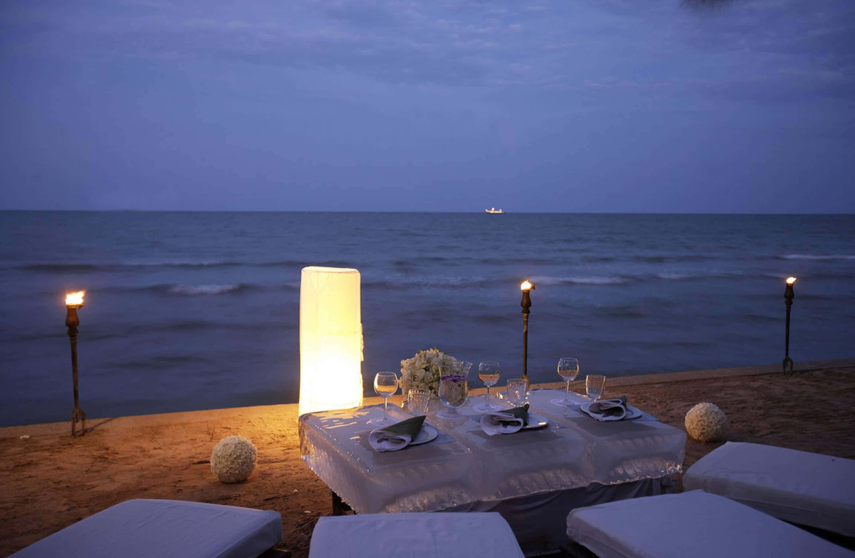 beach picnic, twilight, glowing lanterns, 2K Desktop Wallpaper