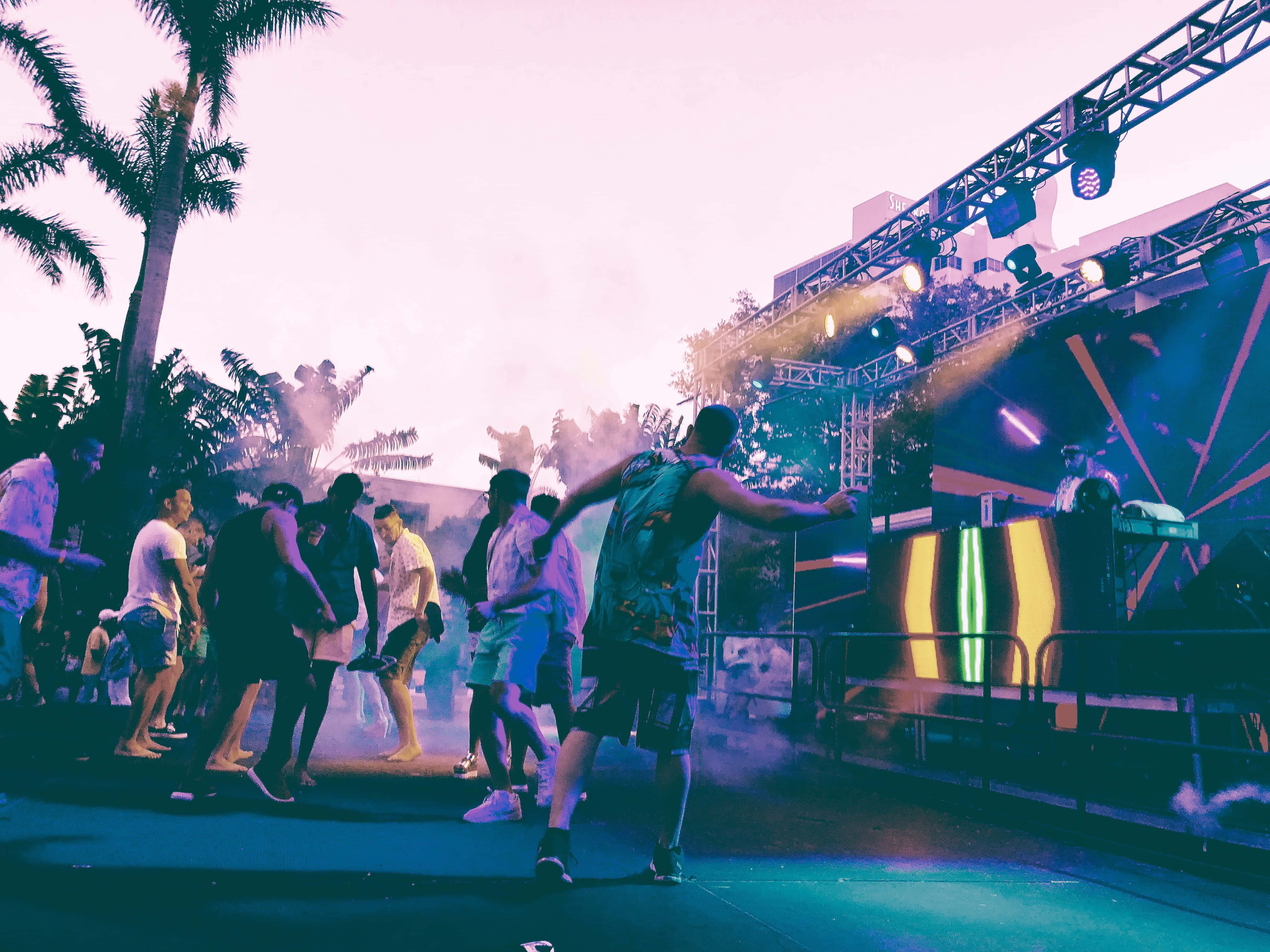 Beach Dance Party, vibrant purple and blue stage lights, outdoor music festival, 4K Desktop Wallpaper