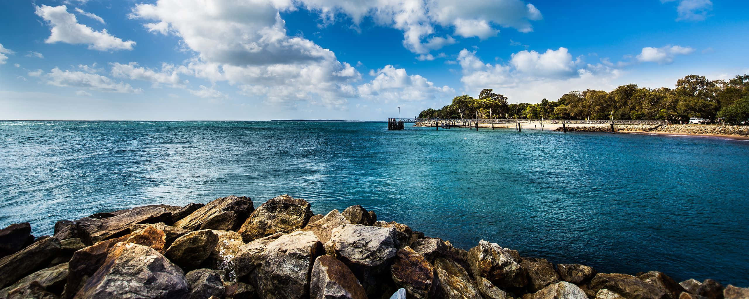 vibrant blue sea, bright sky, fluffy clouds, 2K Desktop Wallpaper