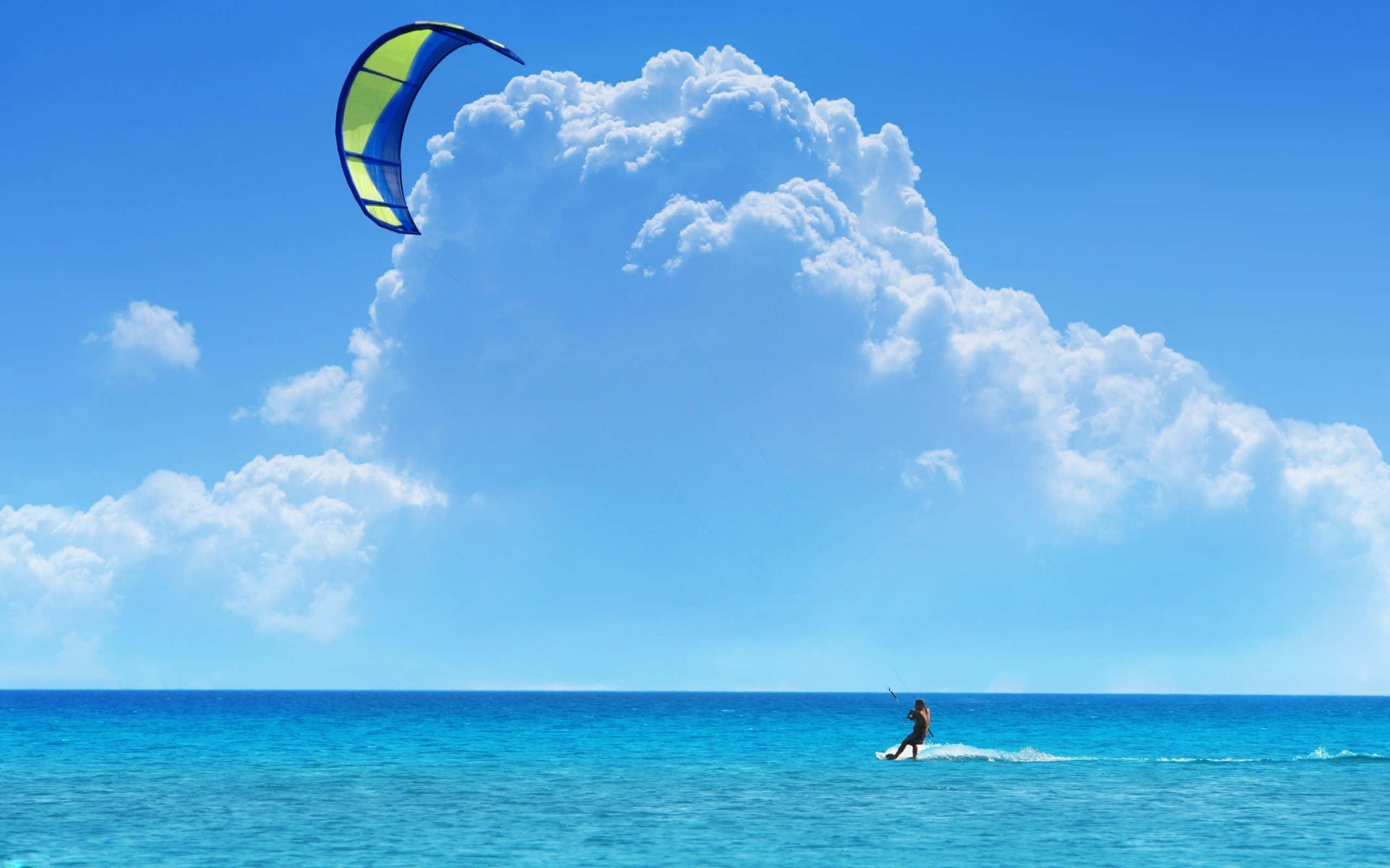 kitesurfer, turquoise ocean waters, vast blue sky, 2K Desktop Wallpaper