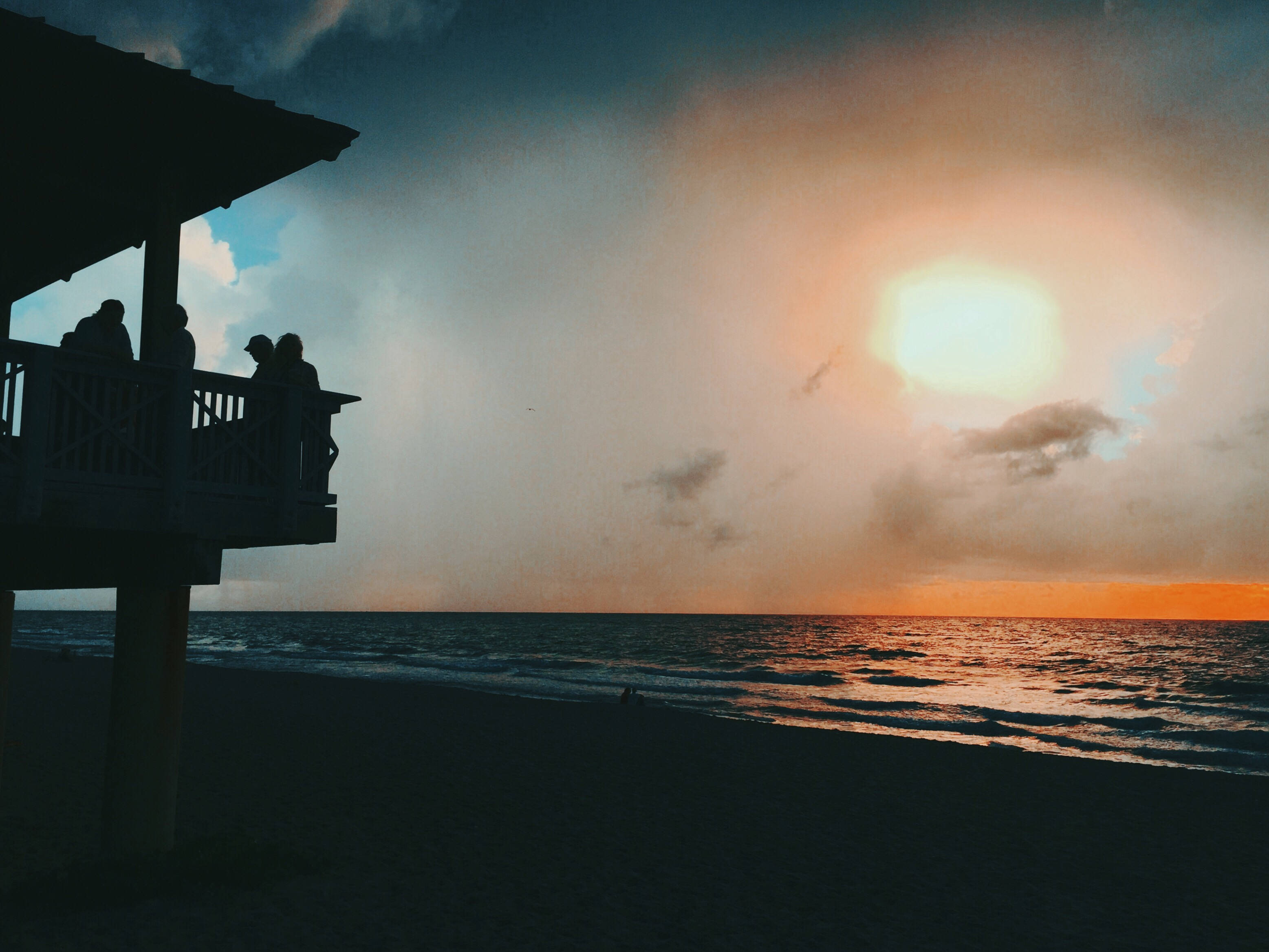 Silhouette Beach House, beachside pier, dramatic sunset, 2K Desktop Wallpaper