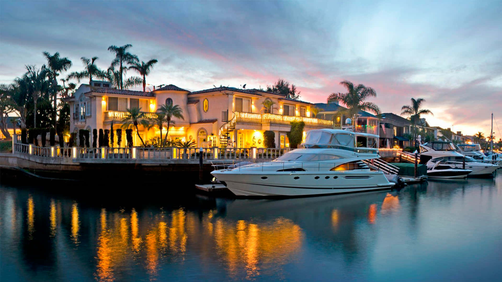 Luxury waterfront mansion, glowing lights, docked yachts, Full HD Desktop Wallpaper