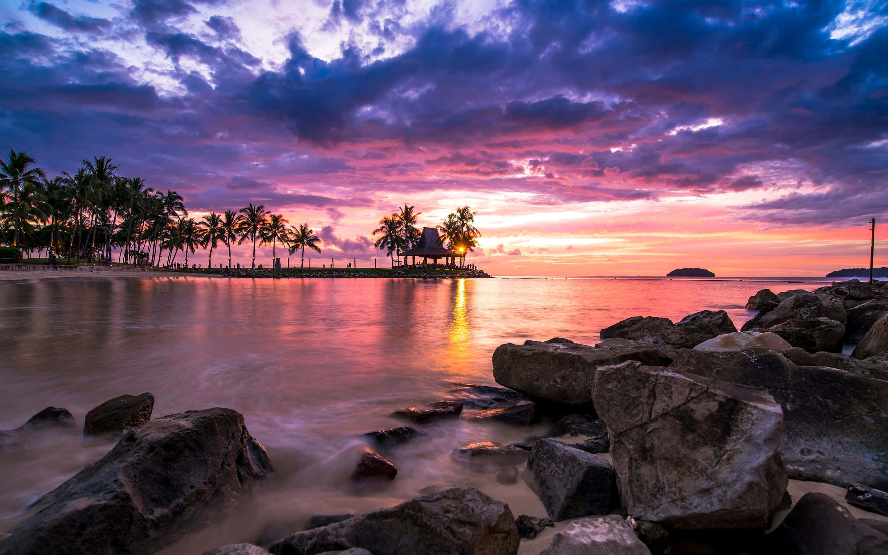 tropical paradise at dusk, sunset, vibrant purple orange sky, 2K Desktop Wallpaper