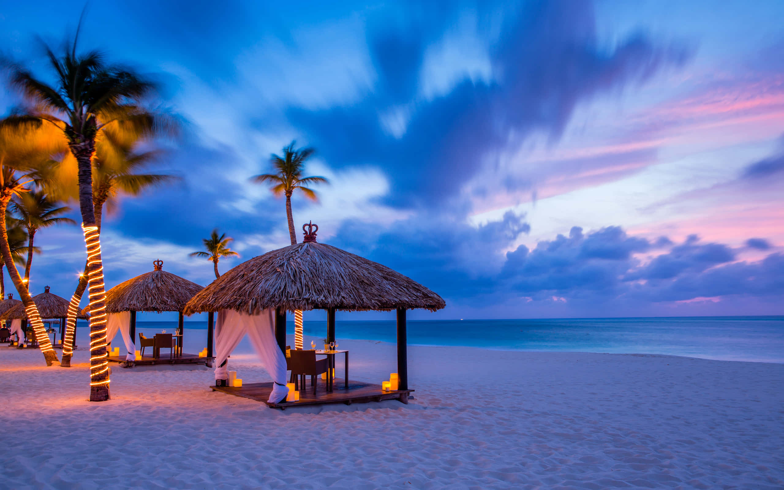 Tropical Beach Resort, twilight beach scene, thatched-roof gazebos, 2K Desktop Wallpaper