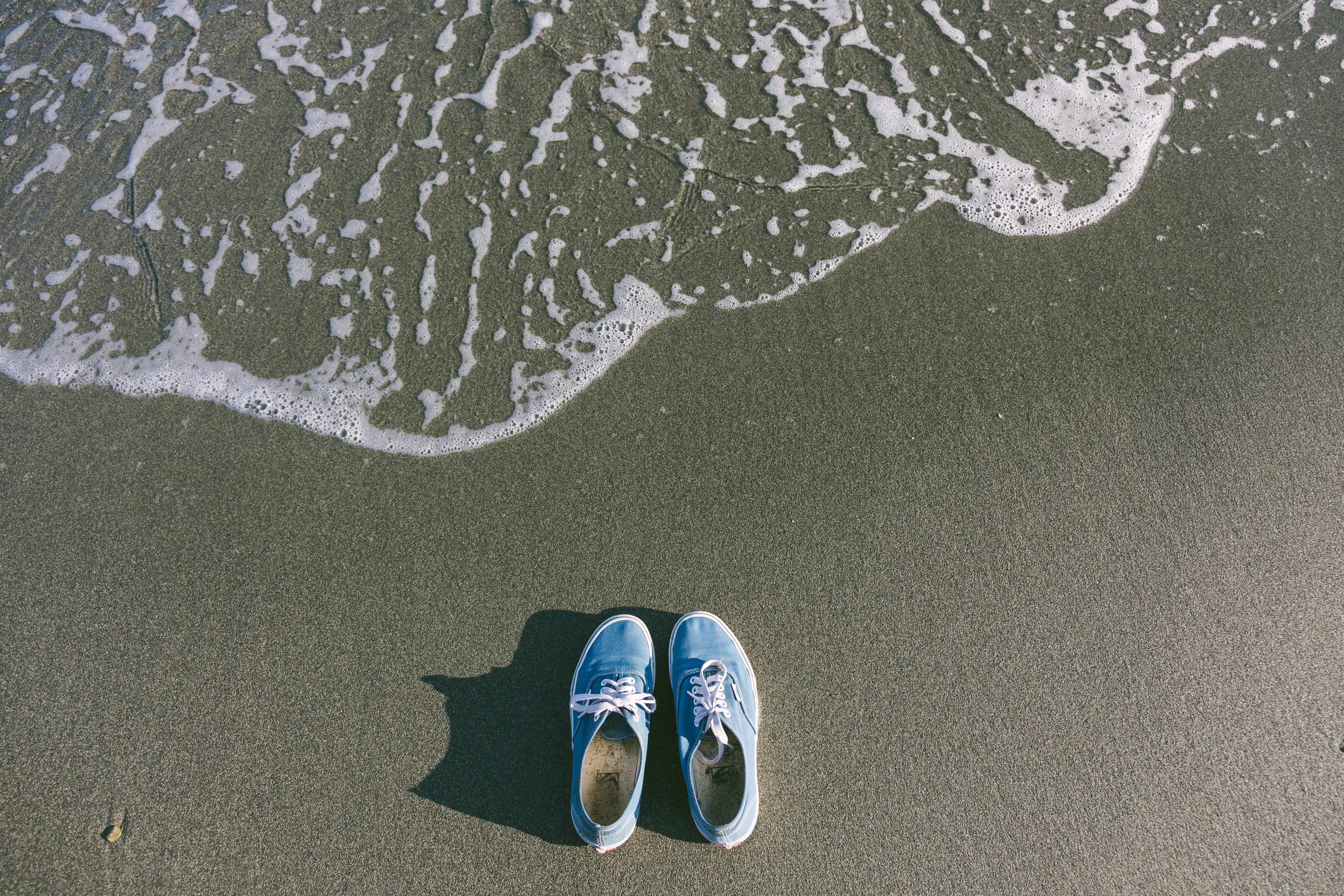 light blue sneakers, wet sand, ocean waves, 5K Desktop Wallpaper
