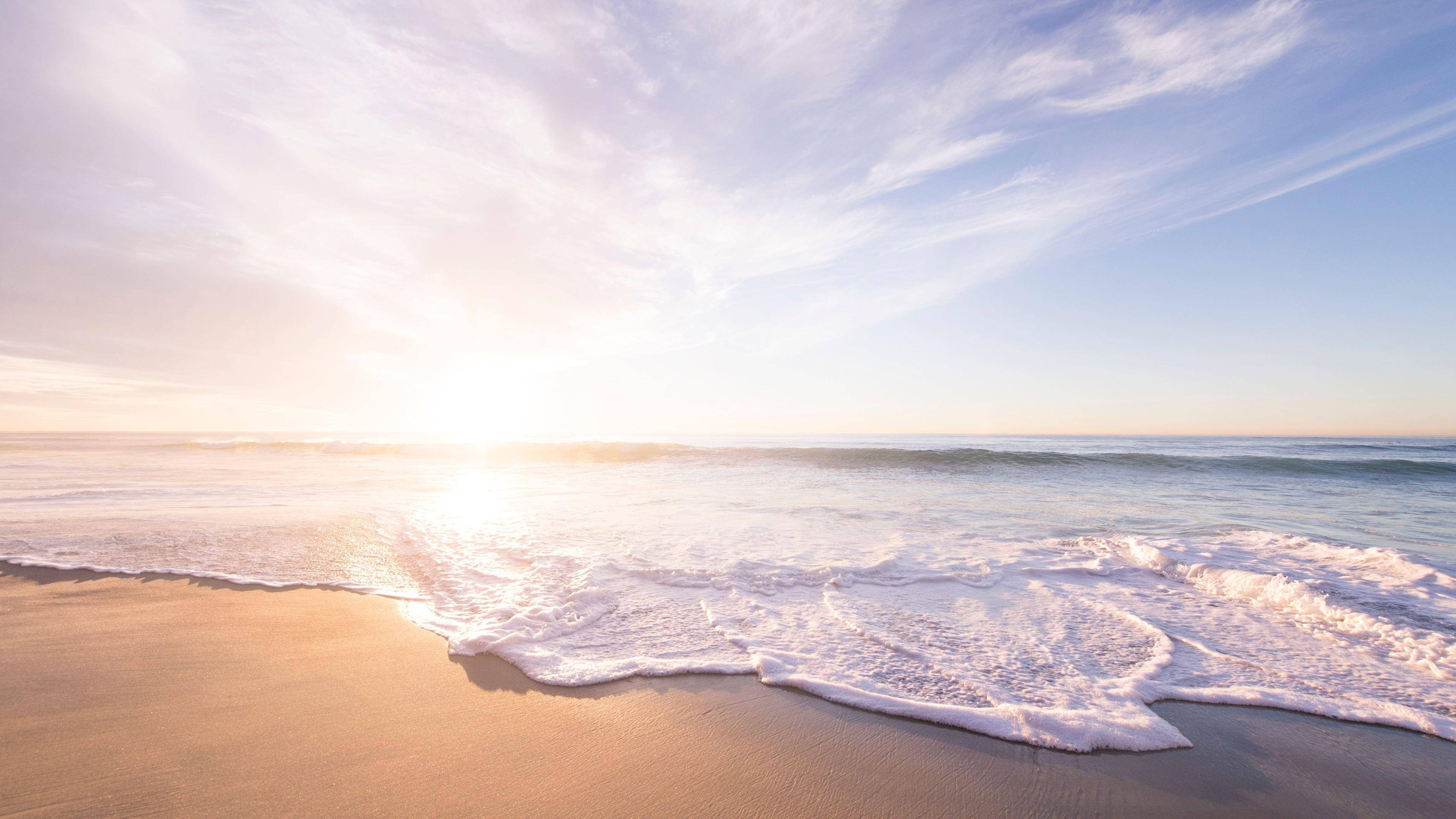 Golden sunrise, gentle ocean waves, sandy beach, 4K Desktop Wallpaper