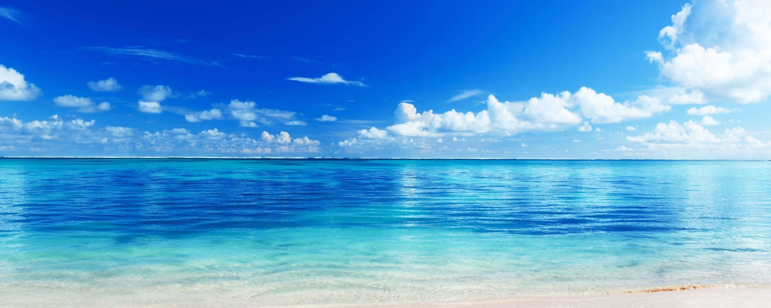 turquoise ocean, white sand, bright blue sky, 2K Desktop Wallpaper