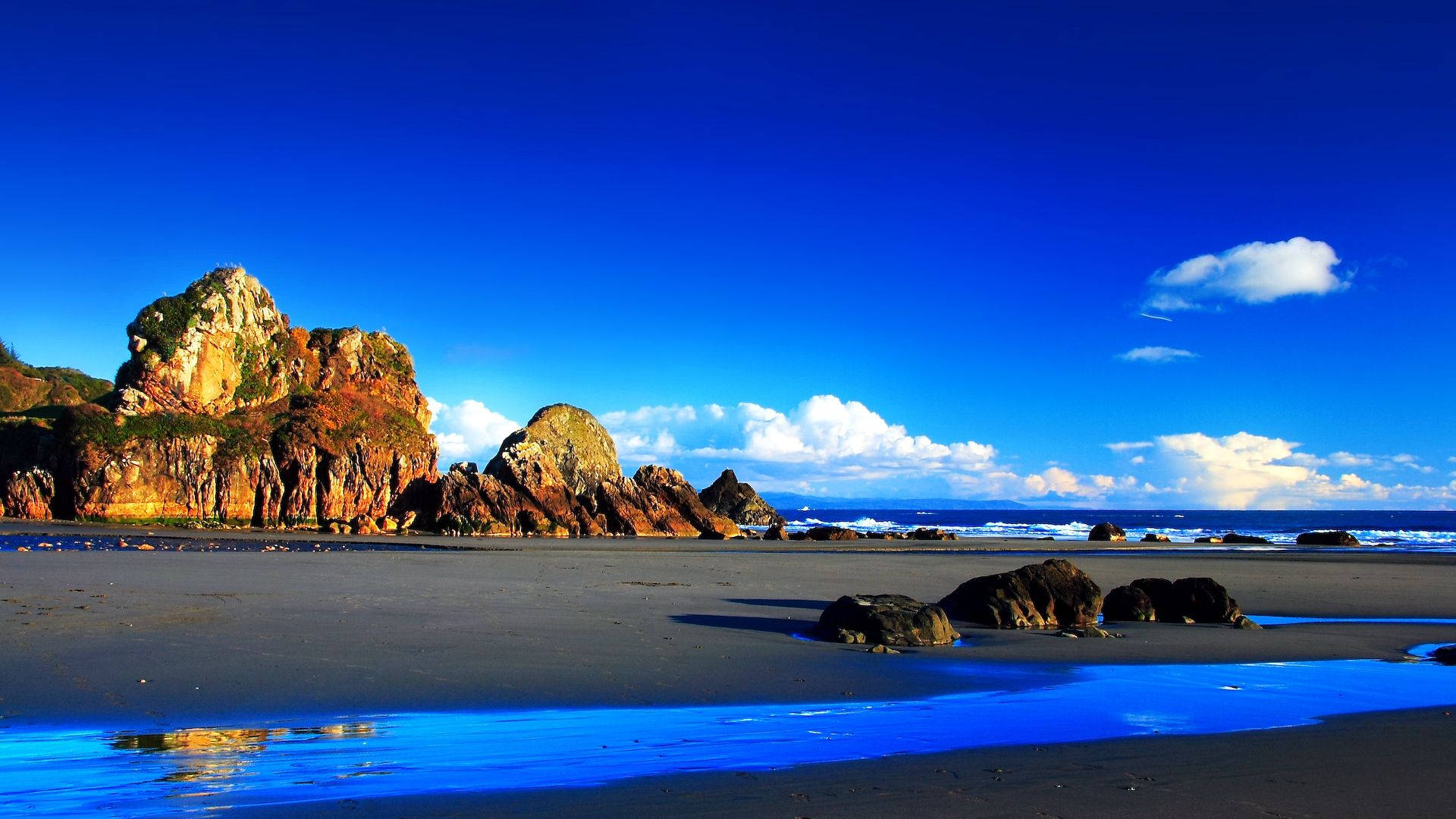 Vibrant blue sky, ocean, dramatic rocky cliffs, Full HD Desktop Wallpaper