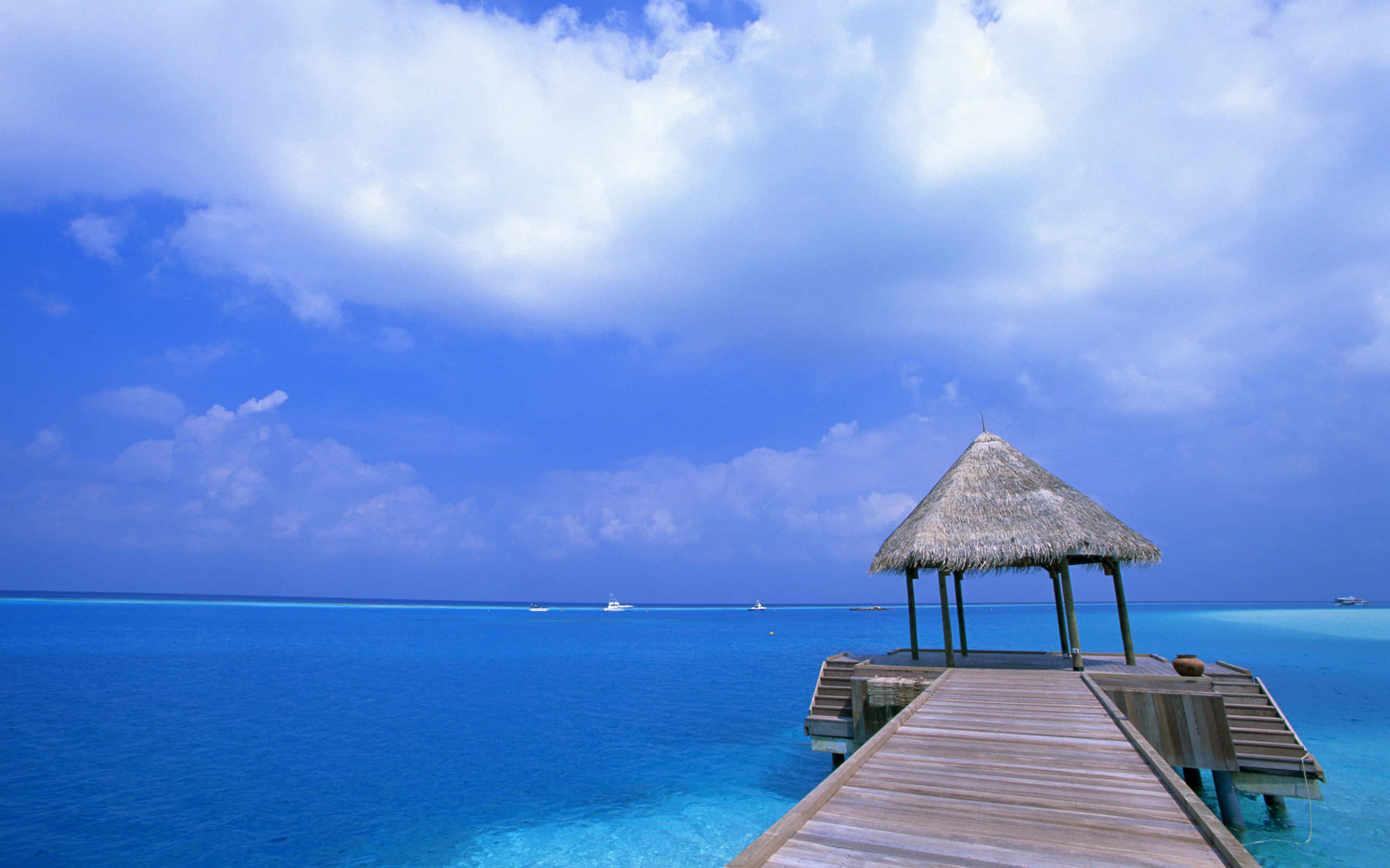 wooden pier, turquoise ocean water, thatched-roof gazebo, 2K Desktop Wallpaper