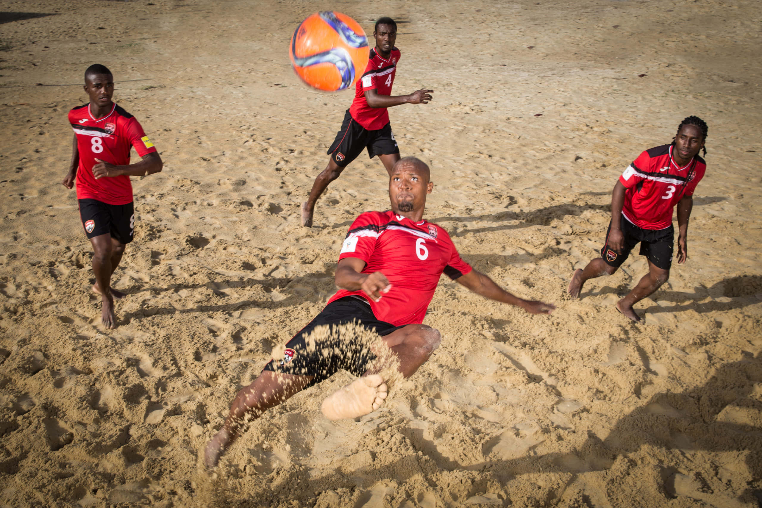beach soccer, red jerseys, sunlit sand, 2K Desktop Wallpaper